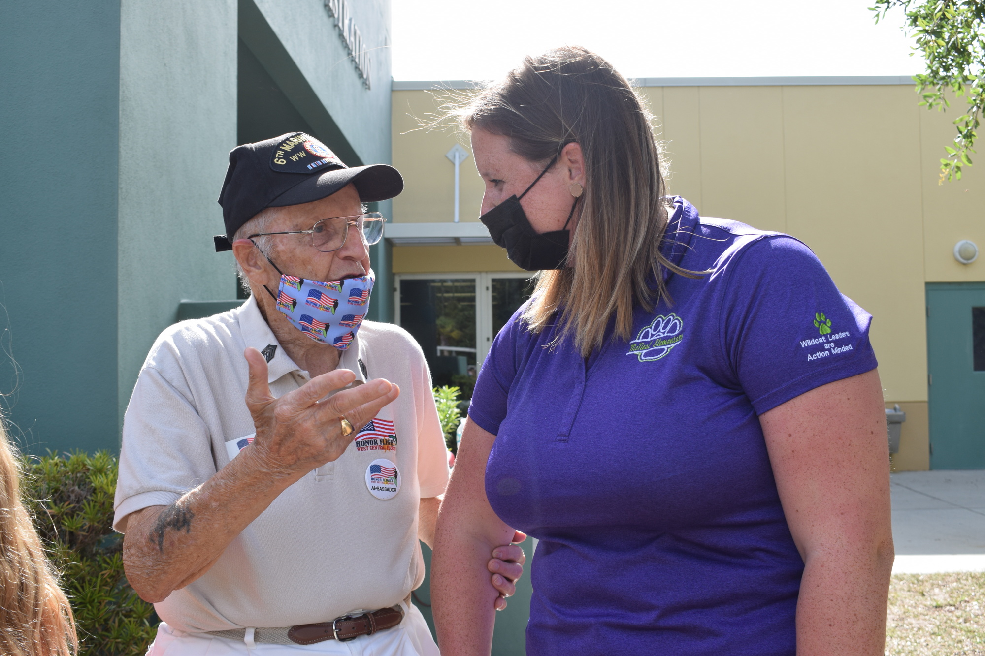 O'Neil Ducharme, a Marine Corps veteran and Honor Flight ambassador, talks to Olivia Swartling, a fifth grade teacher at Gilbert W. McNeal Elementary School.