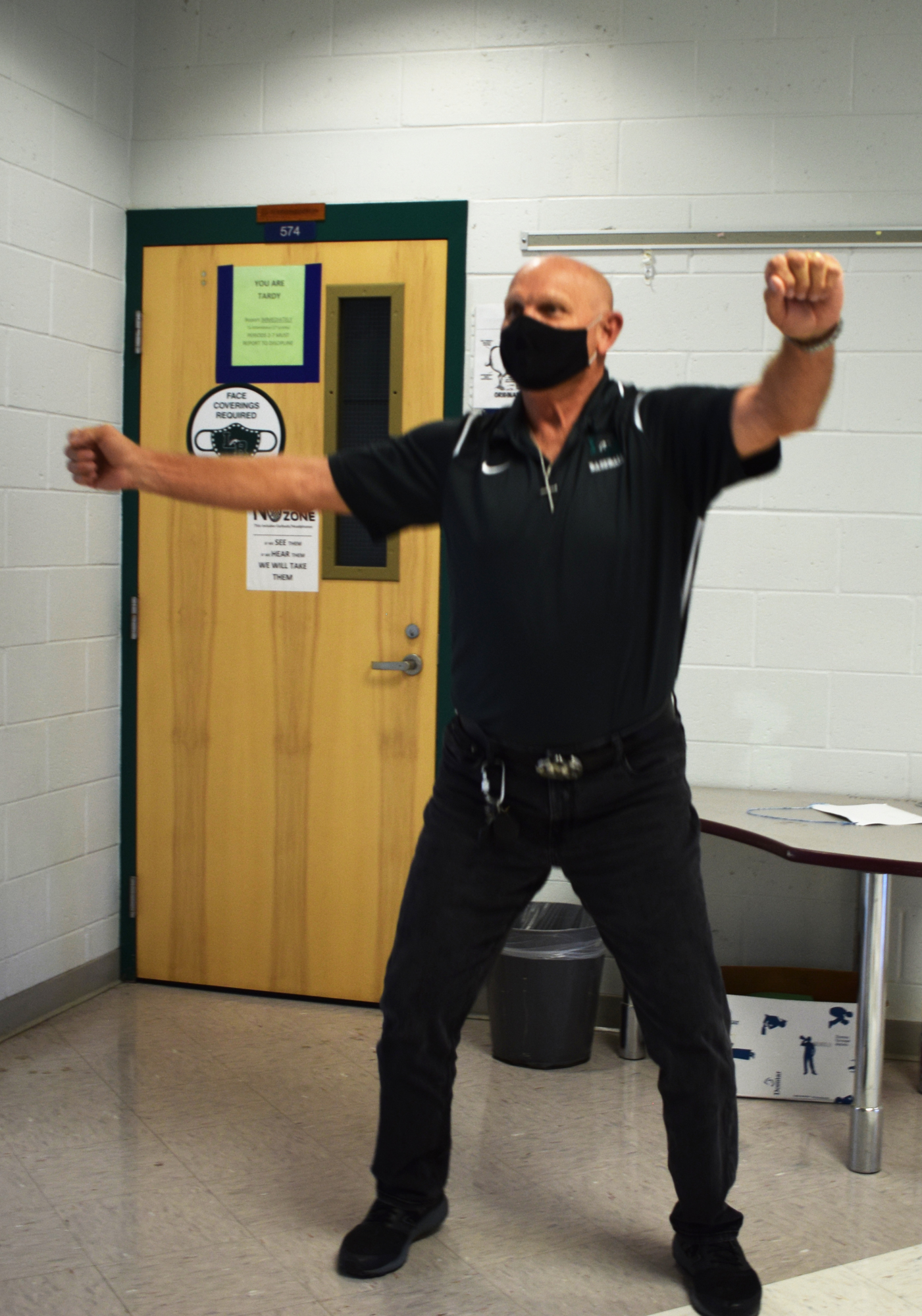 Faust DeLazzer, a science teacher at Lakewood Ranch High School, dances in the hallway between class periods to put a smile on students' faces.