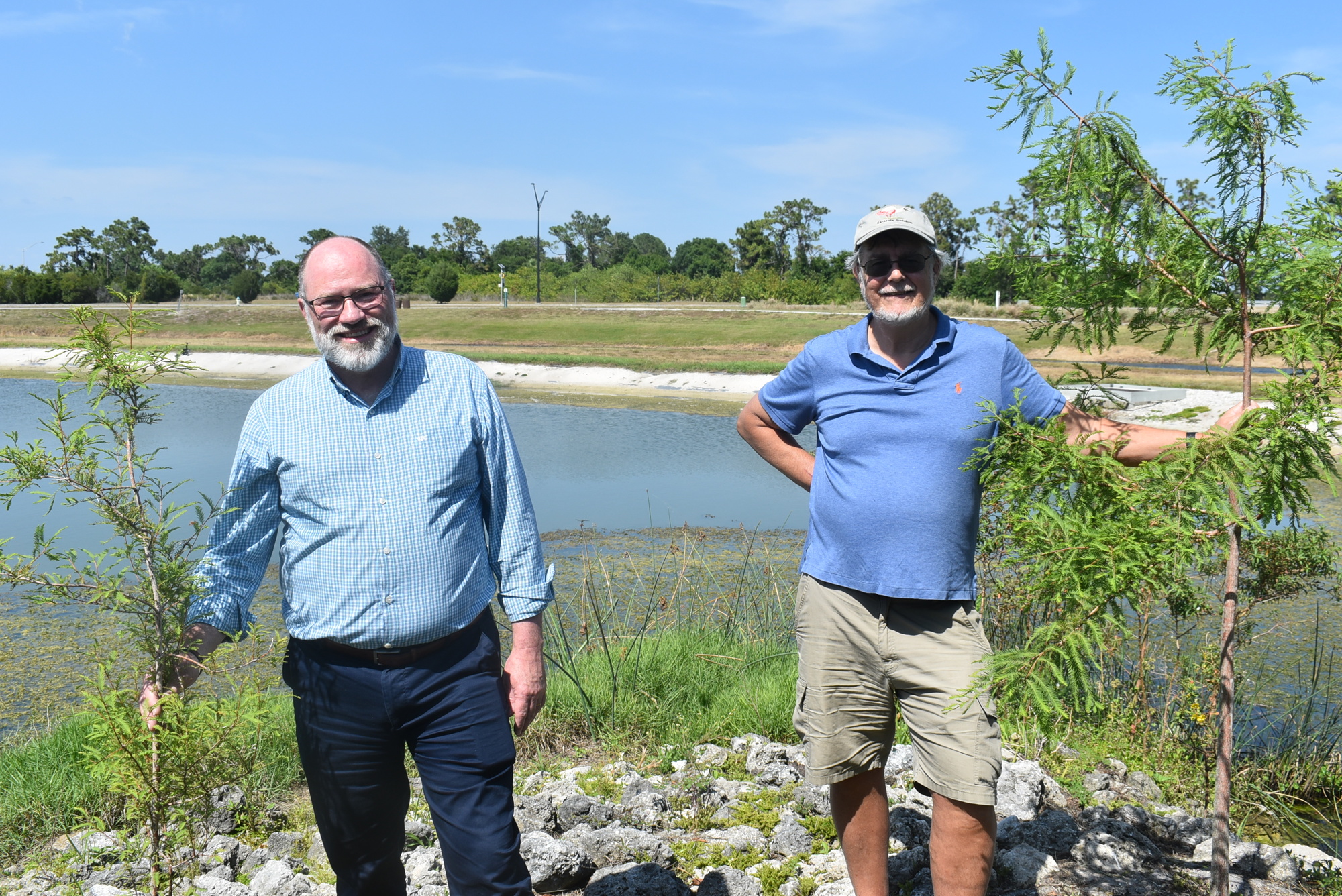 Suncoast Aquatic and Nature Center Associates President and CEO Tomás Herrera-Mishler and Southface Institute Science Advisor Charles Reith stand among trees that will soon become part of a microforest at Nathan Benderson Park.
