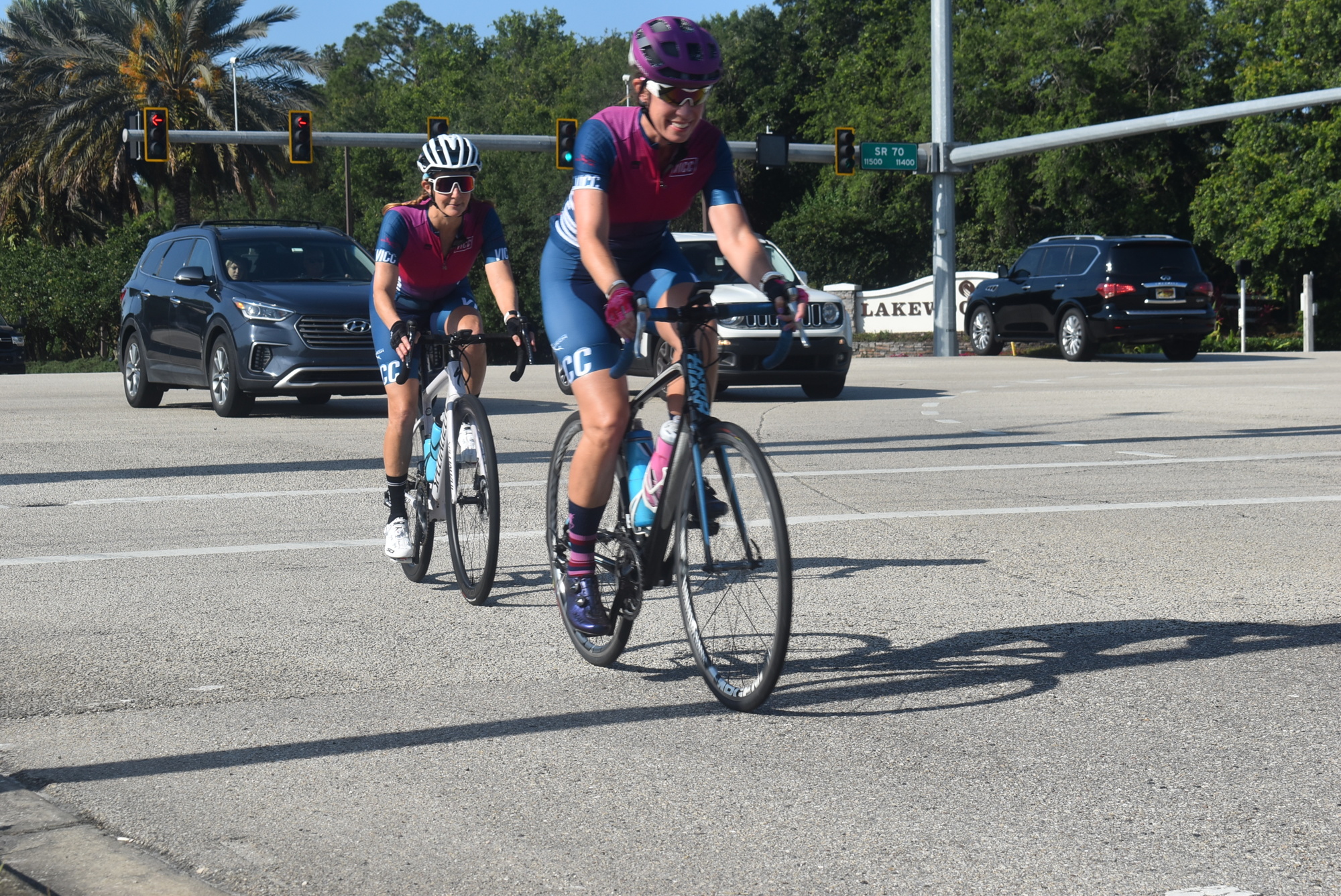Village Idiots Cycling Club members Andrea Sacchetti and Dawn Zielinski finish crossing State Road 70 on Lakewood Ranch Boulevard. A bike lane will soon be reinstated at the intersection on southbound Lakewood Ranch Boulevard.