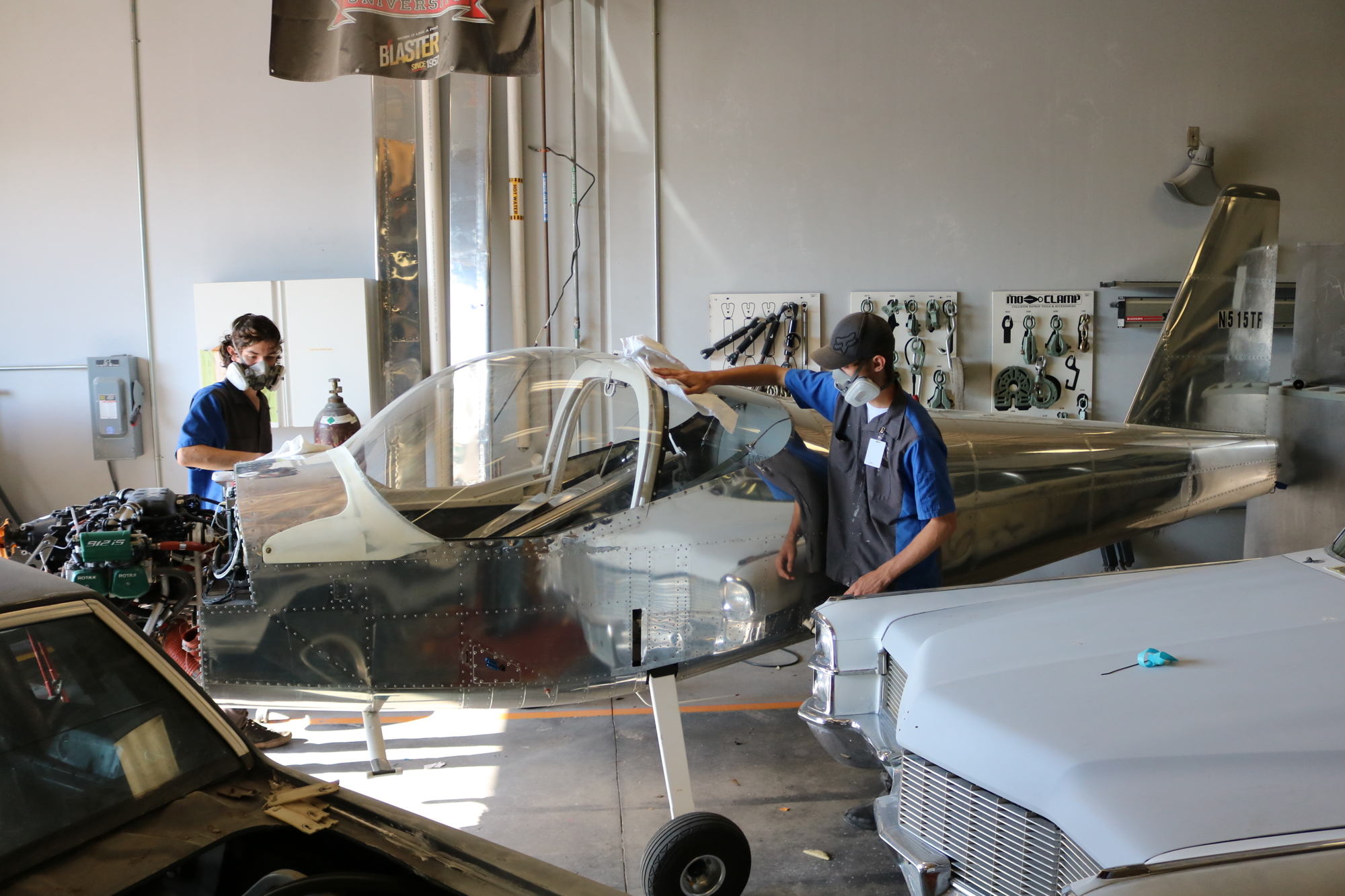 Ryder Wahlsmith and Ryan Yates, who are Manatee Technical College Auto Collision Technology students, wipe down the airplane to prepare to paint it. Courtesy photo.