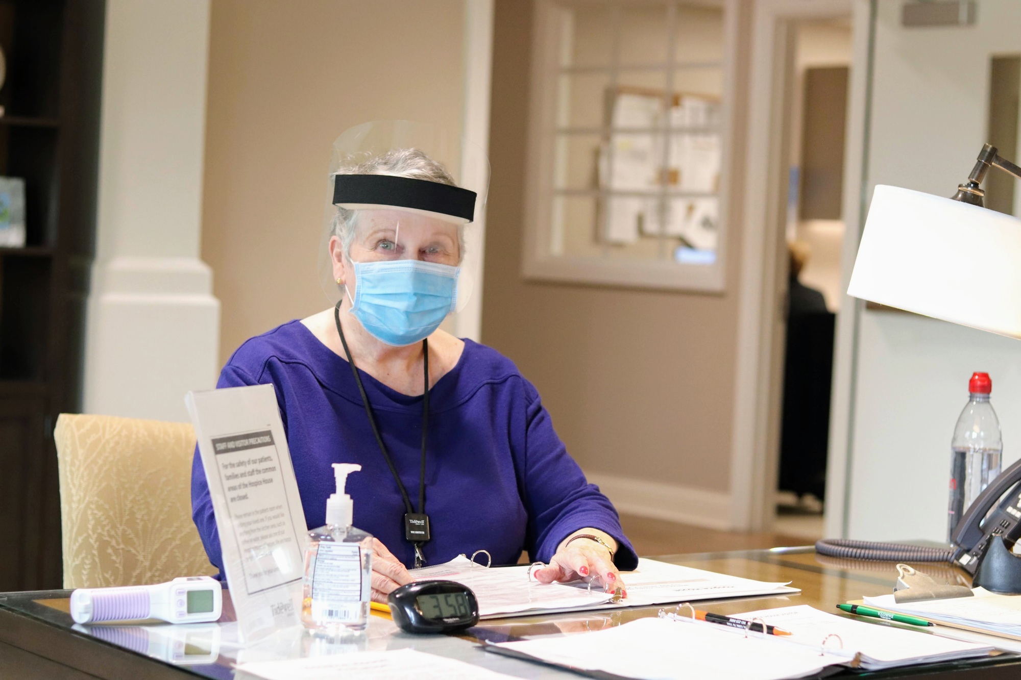 Lynda Anderson works as a host, taking temperatures and enforcing visitor restrictions, during the early months of 2021. She has finally started working in her preferred role of patient support once more. Courtesy photo.