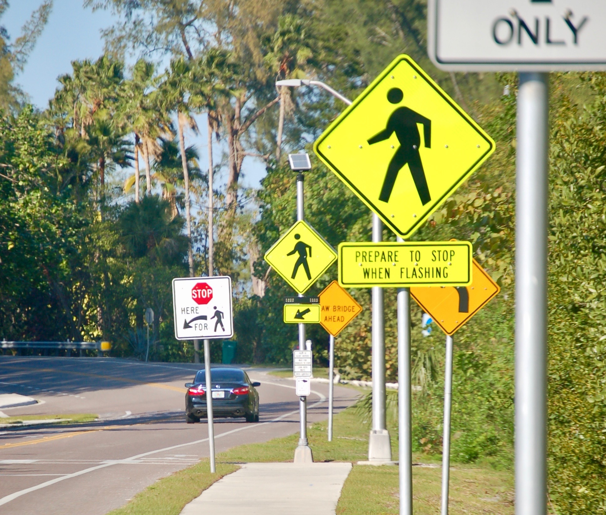 A signalized crosswalk is about 100 yards north of  Gulf of Mexico Drive's intersection with Broadway Street. 