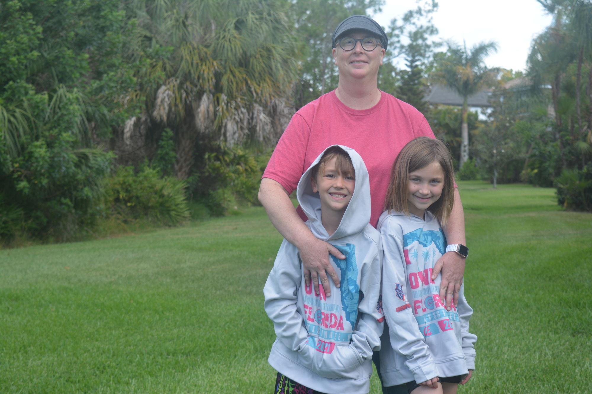 Christin Perkinson (middle) has stayed strong through her breast cancer diagnosis thanks to the supports of her kids, Ellie Perkinson and Isaac Perkinson. Isaac is raising money for the Pin Cancer Nationals wrestling tournament.