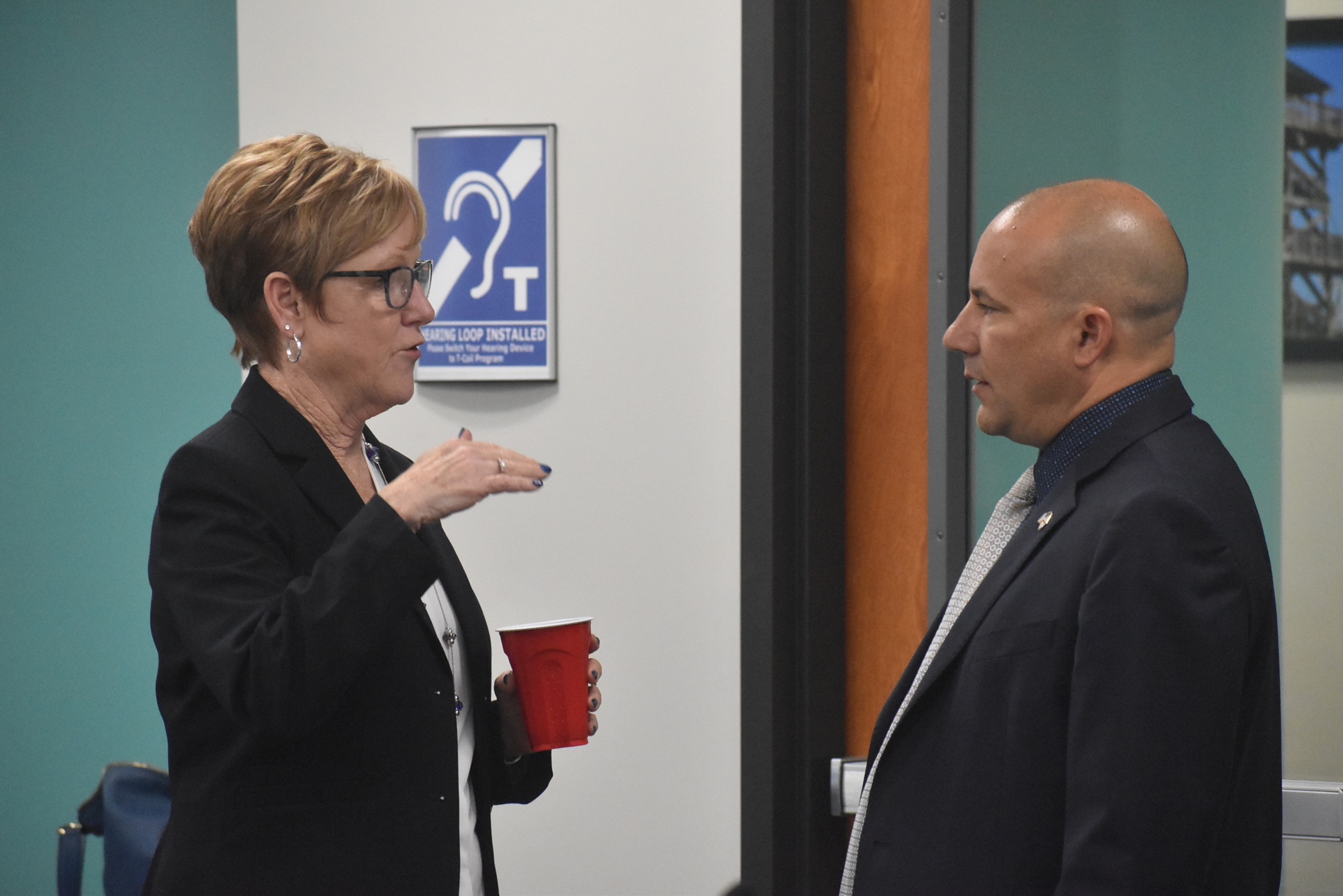Deputy Administrator Karen Stewart talks with Manatee County Commissioner Kevin Van Ostenbridge, who advocated in favor of downsizing the future East County library to the cost originally budgeted three years ago.