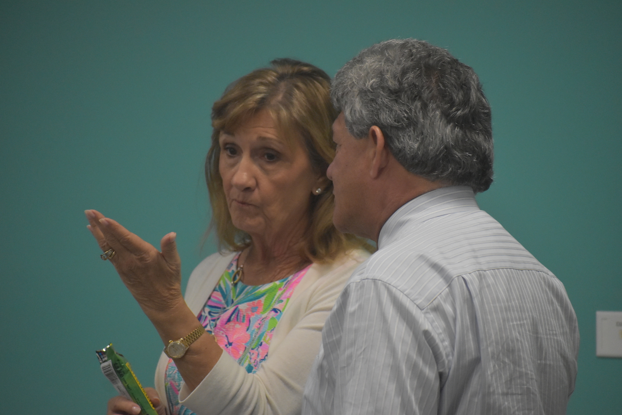 Commissioner Vanessa Baugh, pictured talking with Administrator Scott Hopes, said commissioners should take a close look at the future East County library's budget and ensure every item is necessary for the library's success.