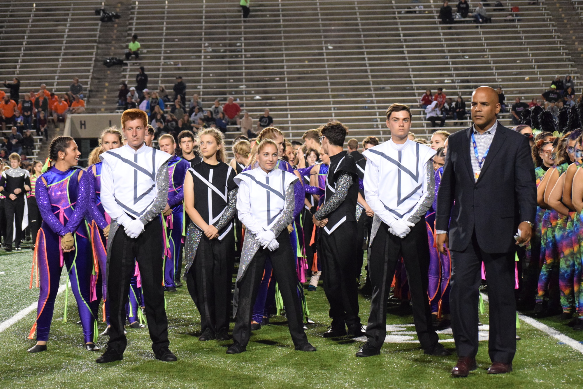 Members of the Marching Mustangs and Ron Lambert, the director of bands, await the results of the 2019 state championship. The band placed third. File photo.