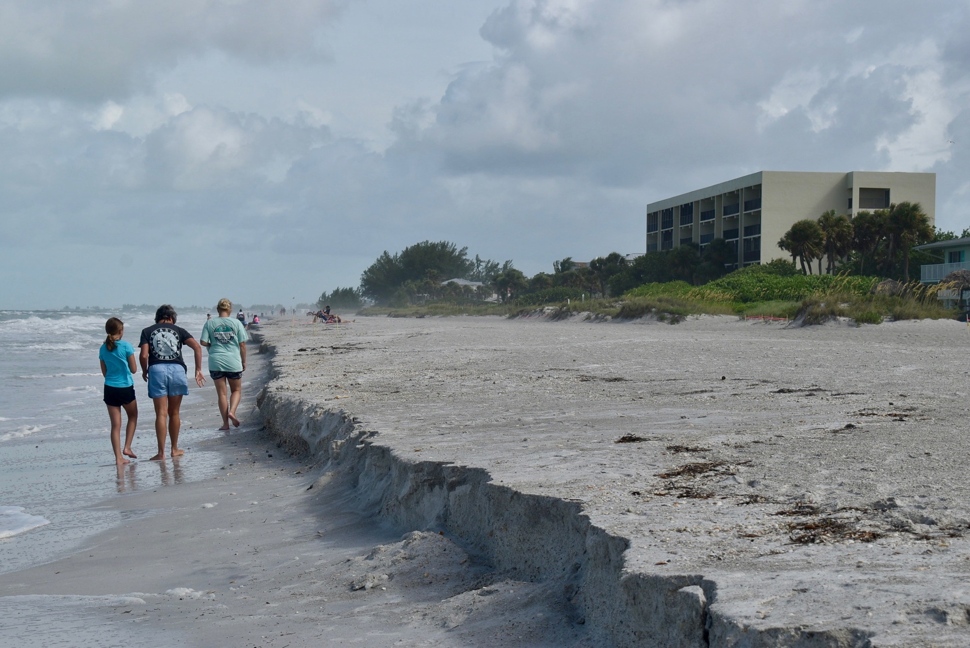 Amy Baker, Lysette Daniels and Marisa Baker check out the beach erosion in the 3100 block of Gulf of Mexico Drive in Longboat Key. (Nat Kaemmerer)