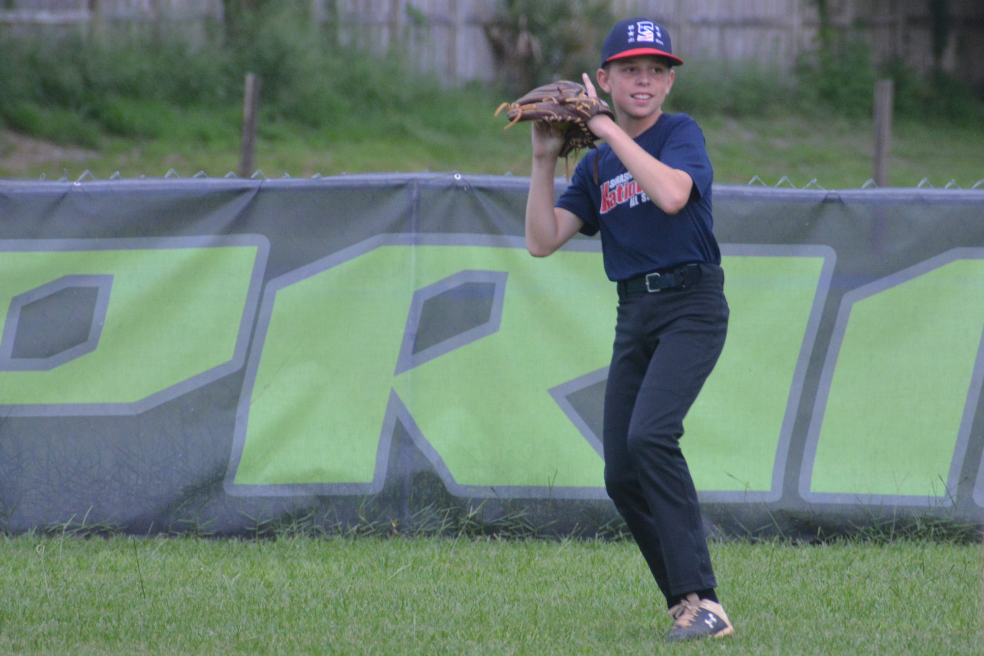 Caden Armstrong makes a catch in the outfield during a Sarasota National practice Monday.