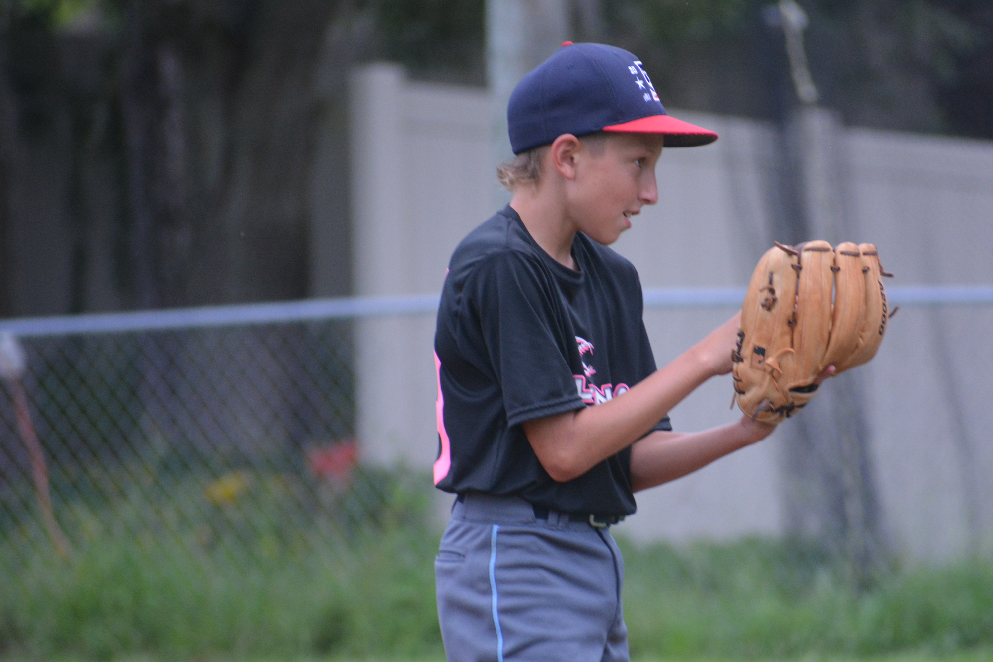 Chase Snelson pretends to pitch during batting practice at Sarasota National's workout Monday.