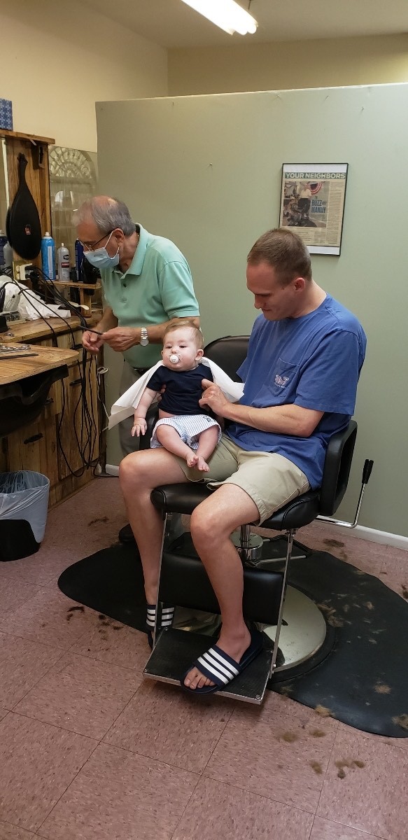 Barber Manny Ninos (left) has cut the hair of three generations of Longboaters. Photo courtesy of Liz Reed.