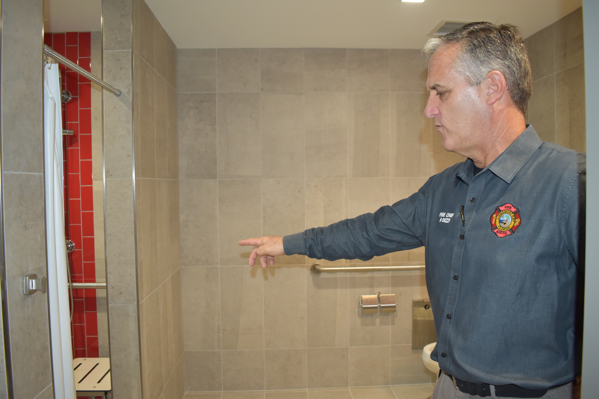 Fire Chief Paul Dezzi demonstrates where firefighters will be required to take their second shower after returning to the station.