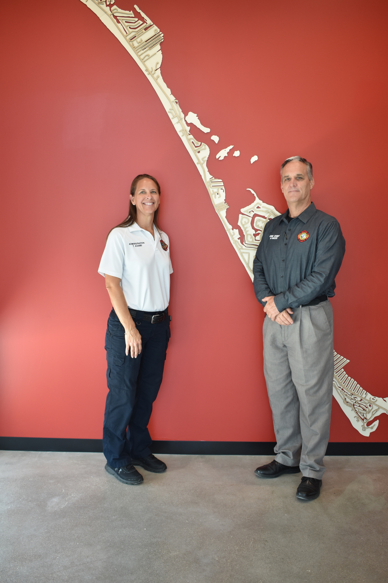 Tina Adams and Paul Dezzi posed for a picture in front of the massive map featured near the entrance of Fire Station 92.