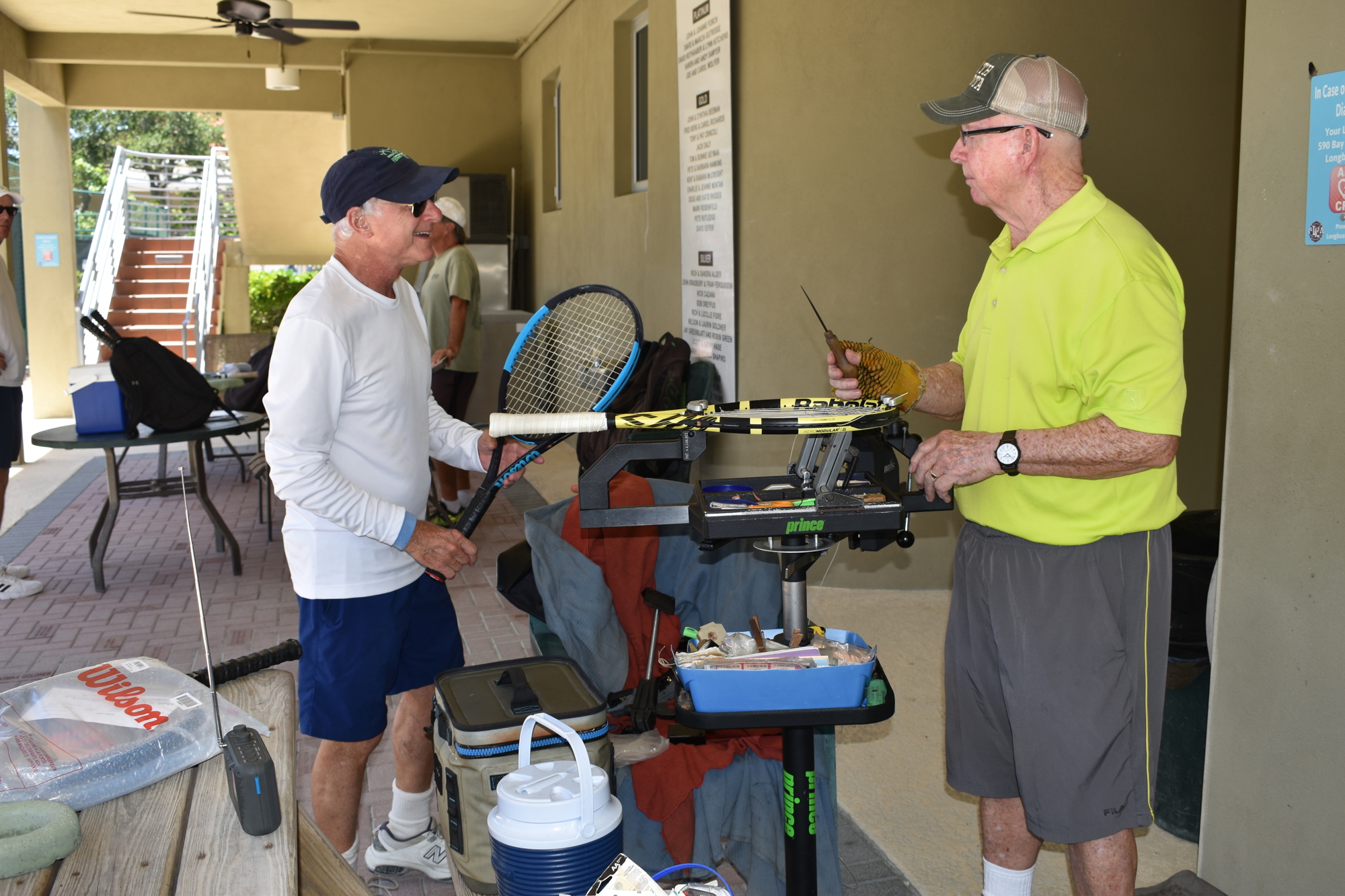 Mark Rosenfeld (left) says hello to Jay Morgan (right) on Monday, Aug. 2 at the Longboat Key Tennis Center.