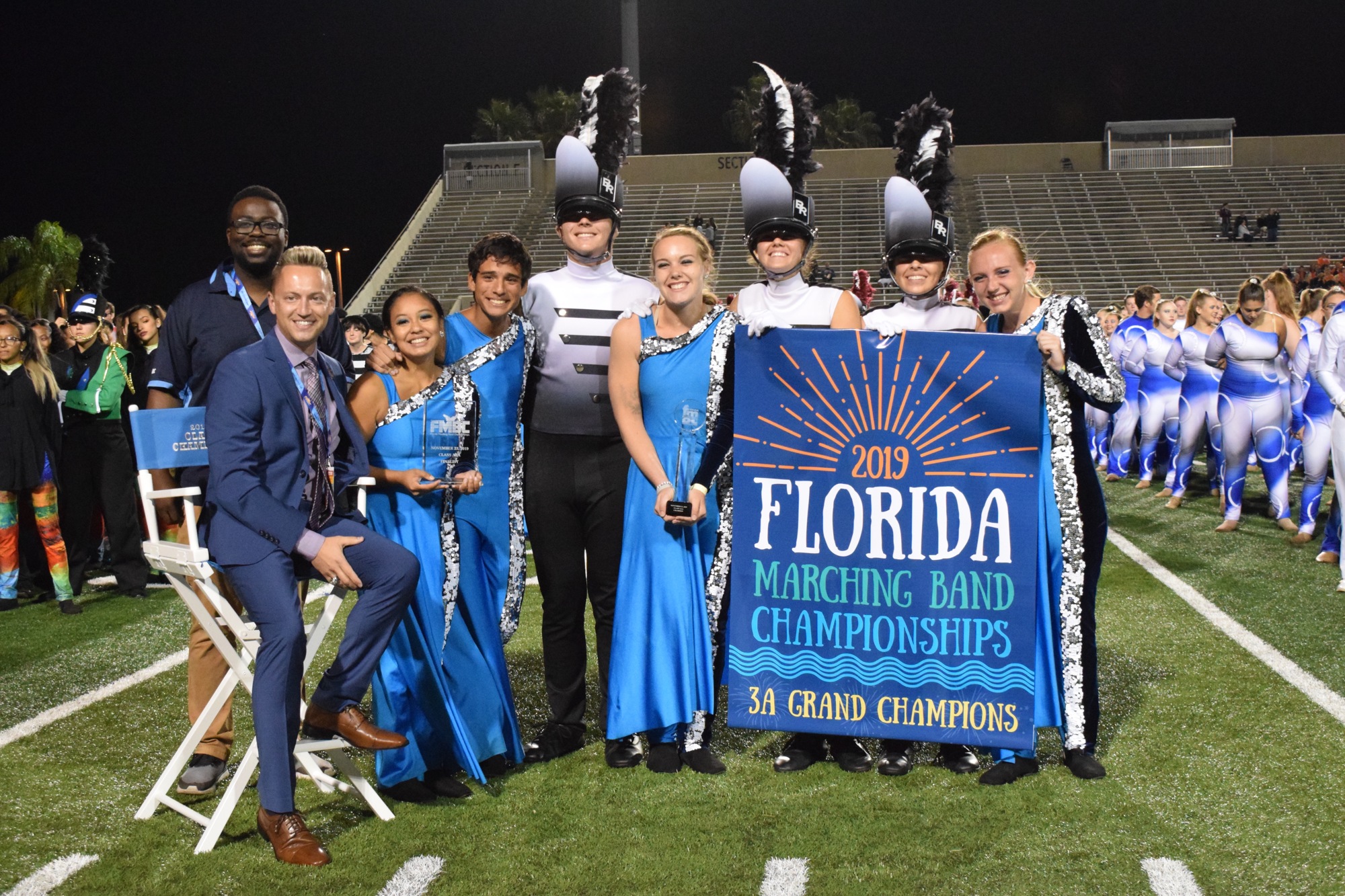 Braden River director Jeramiah Bowman and Marching Band of Pirates leadership commemorate their first place win.