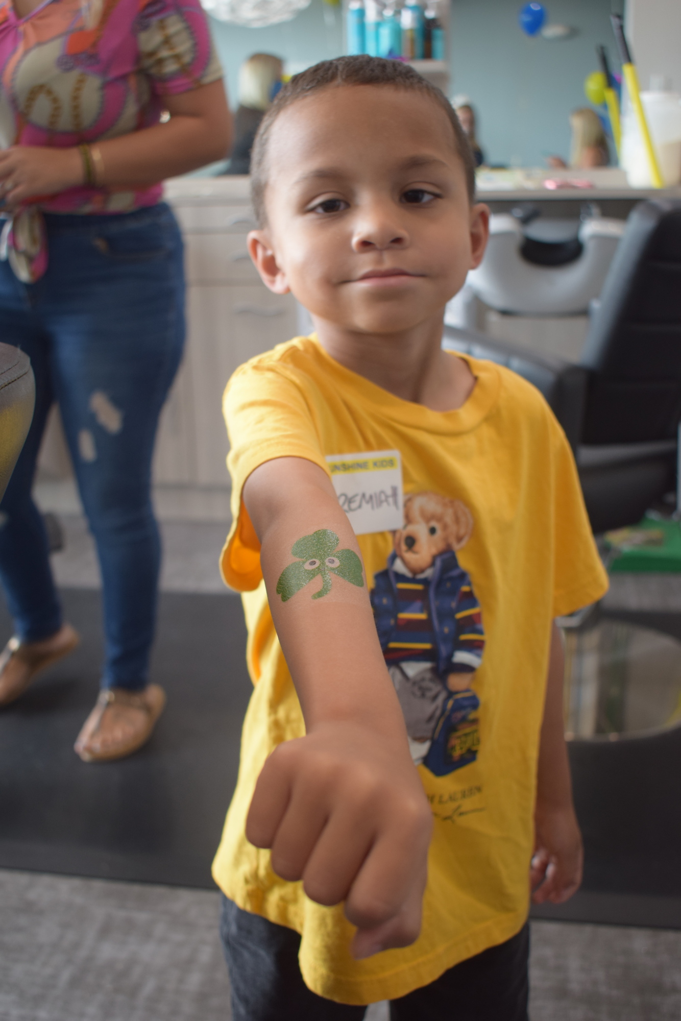 Five-year-old Jeremiah Valera shows off his temporary tattoo during the Sunshine Kids visit to Sirius Day Spa.