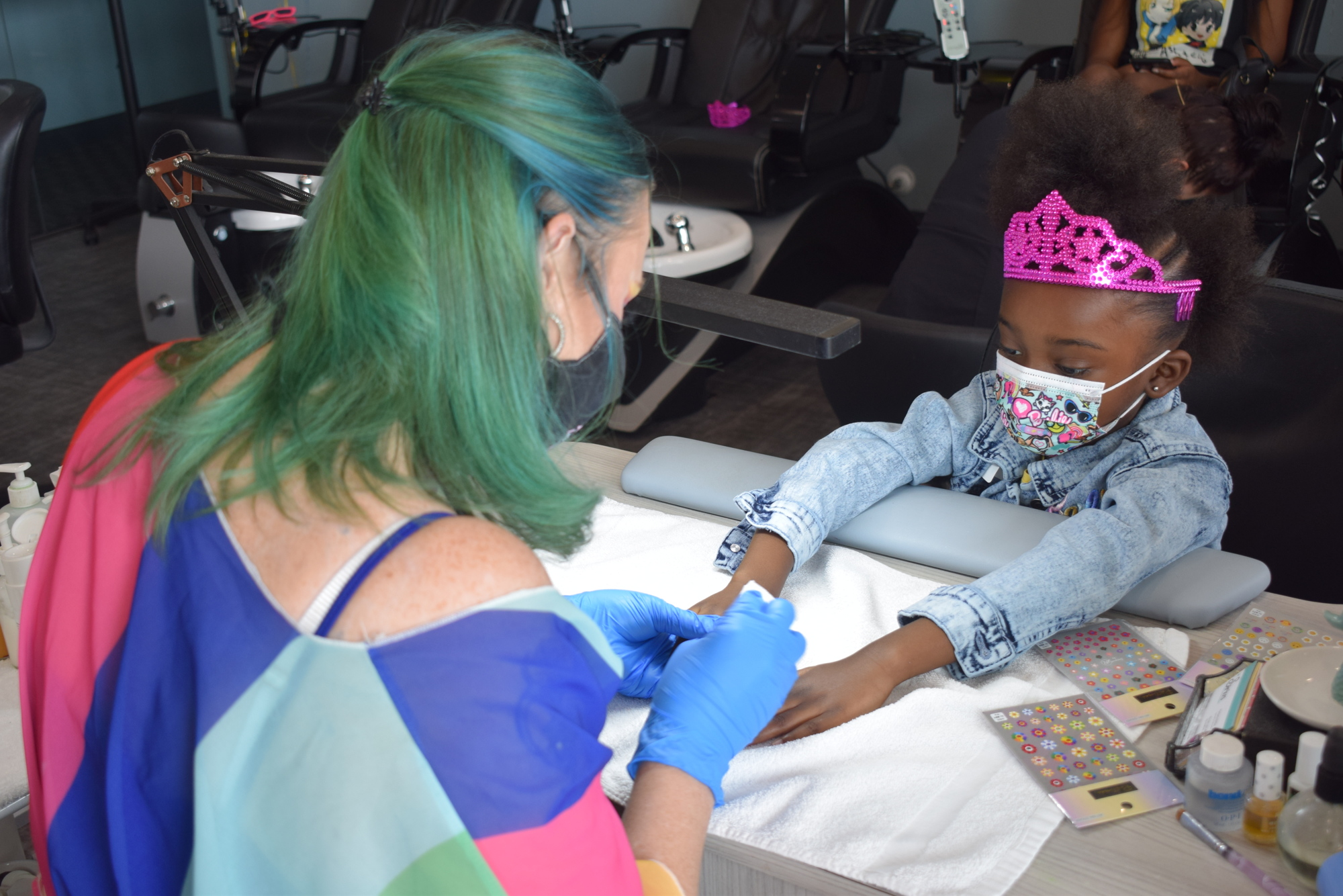 Kimberly Weller of Sirius Day Spa pampers 5-year-old Callie Johnson by doing her nails during a visit by the Sunshine Kids.