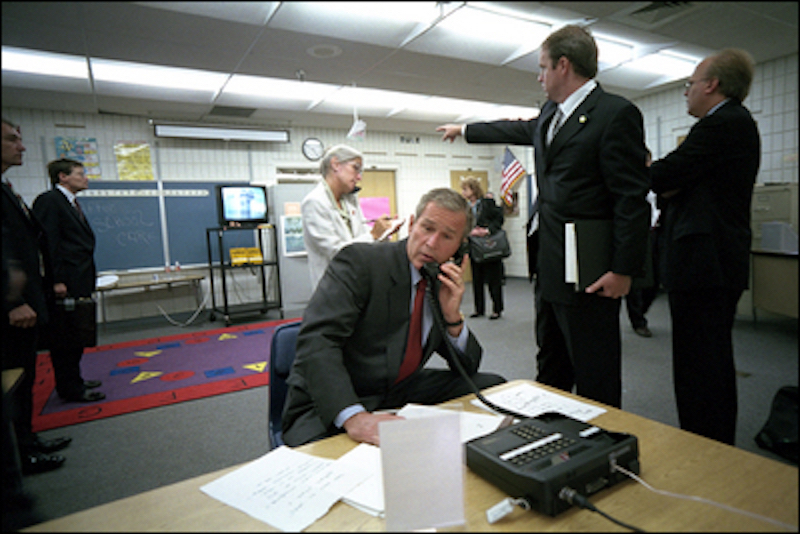 President George W. Bush confers on a secure phone from Emma Booker Elementary. (White House photo)