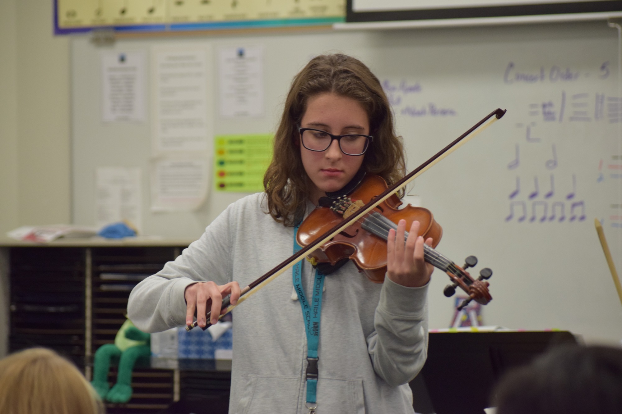 Tiffany Rock, a Carlos E. Haile Middle School seventh grader, demonstrates how to play a few measures of the song 