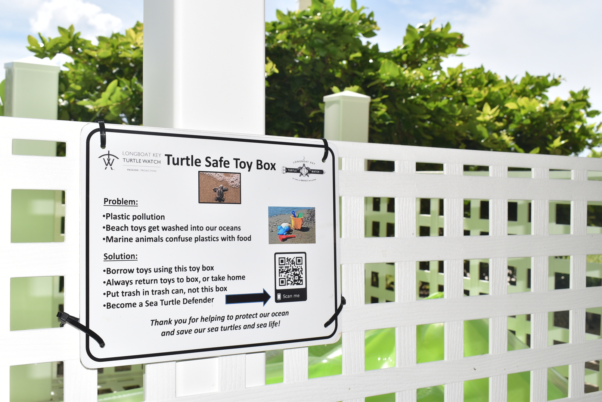 The box is affixed with a plaque with information about sea turtle safety.