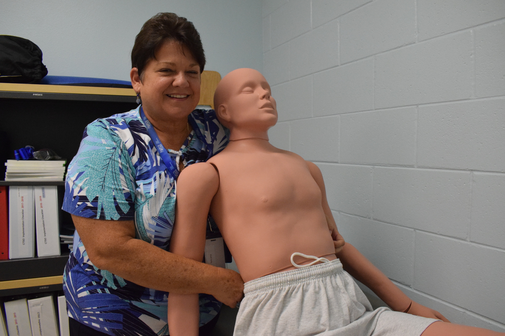 Pam Rahn, a pre-medical teacher and Health Occupations Students of America co-advisor at R. Dan Nolan Middle School, says the life-size mannequin, named Randy, helps students practice health procedures like applying a tourniquet.