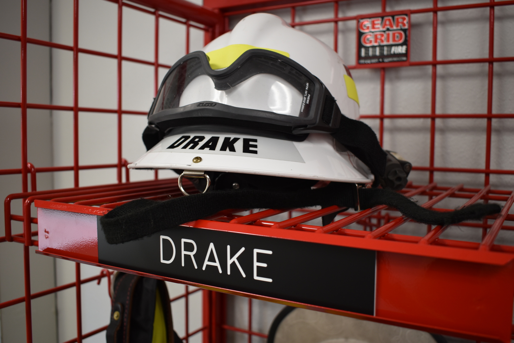 Each firefighter has an area marked with a nameplate to store individual equipment.