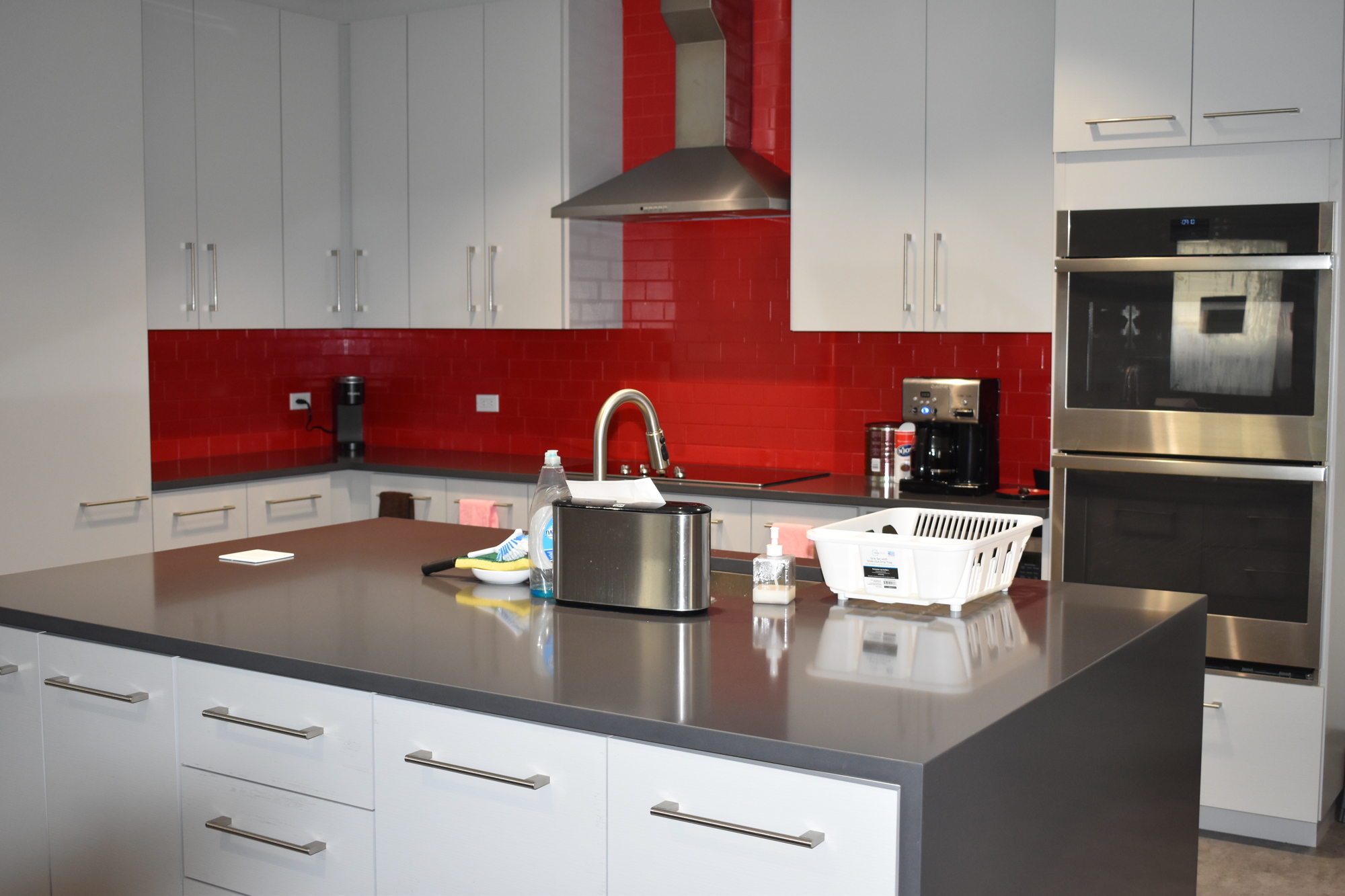 The Fire Station 91 kitchen has an island, a stovetop, a microwave, a dishwasher and two ovens.