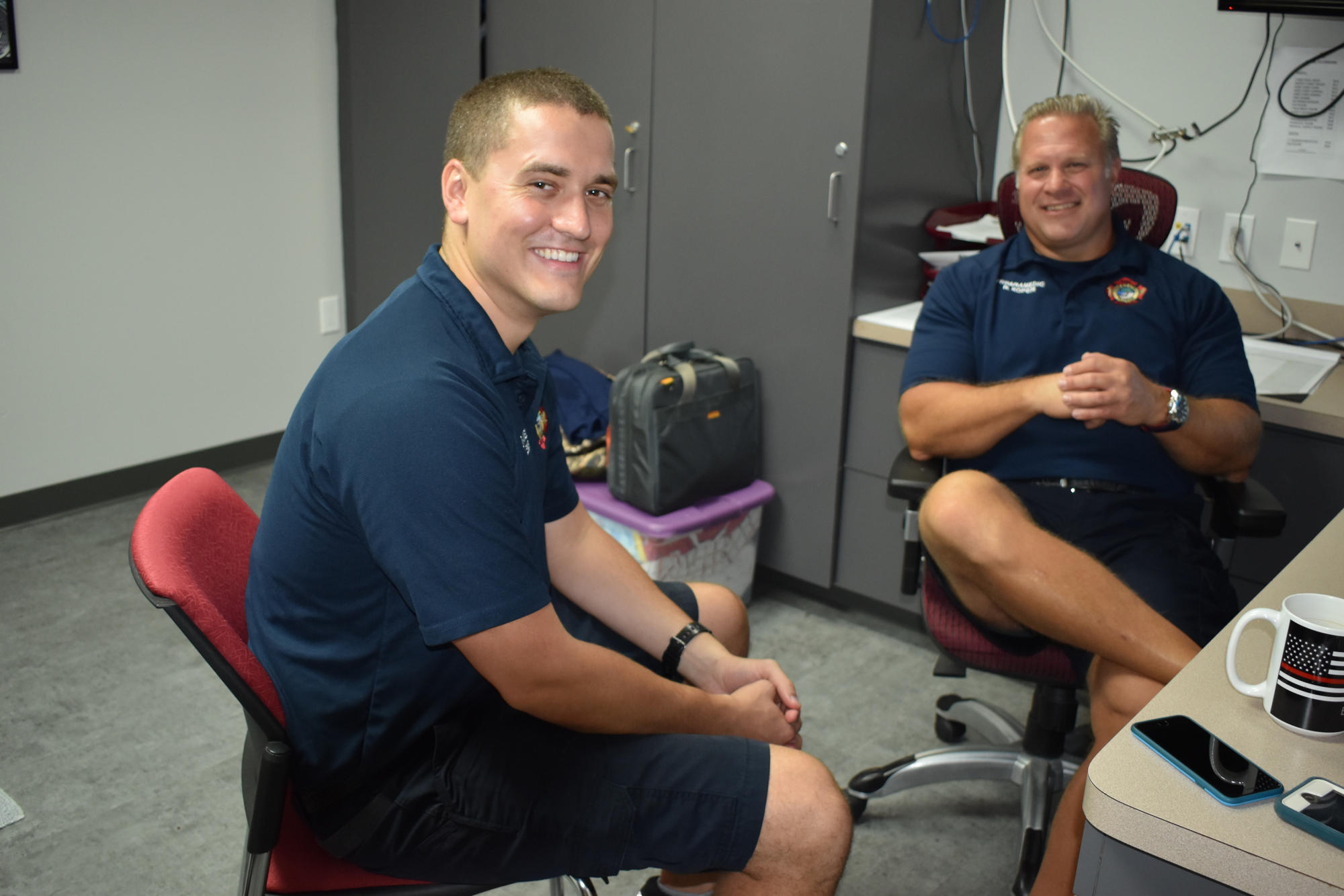 Firefighter-paramedic William Lewis and firefighter-parameic Ron Koper sit inside one of Fire Station 91's bedrooms.