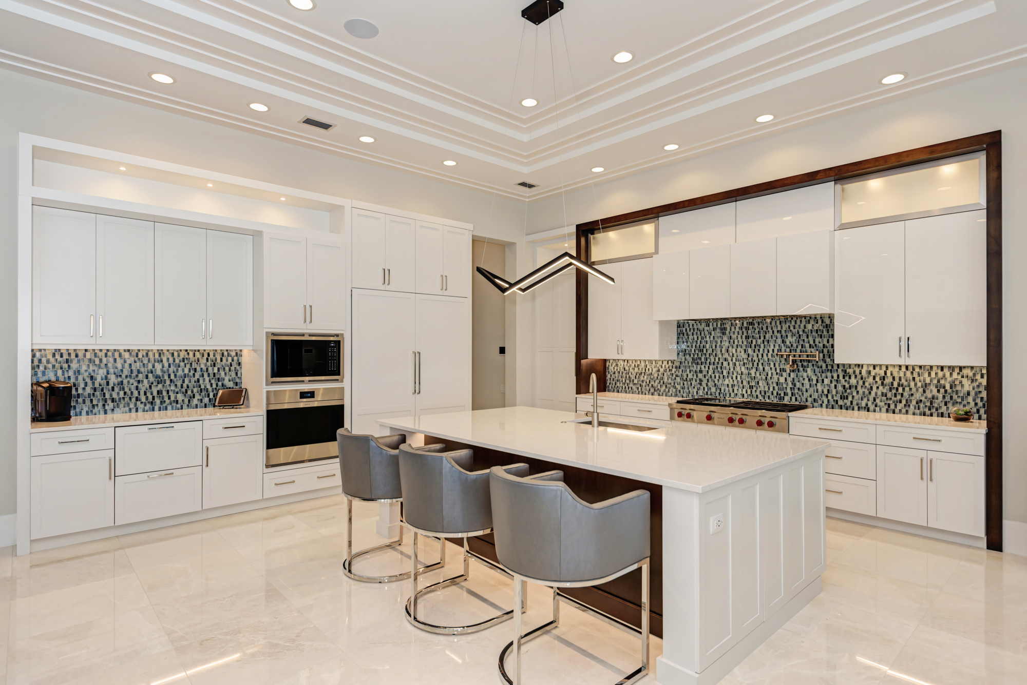 The kitchen features custom cabinetry and a large center island.