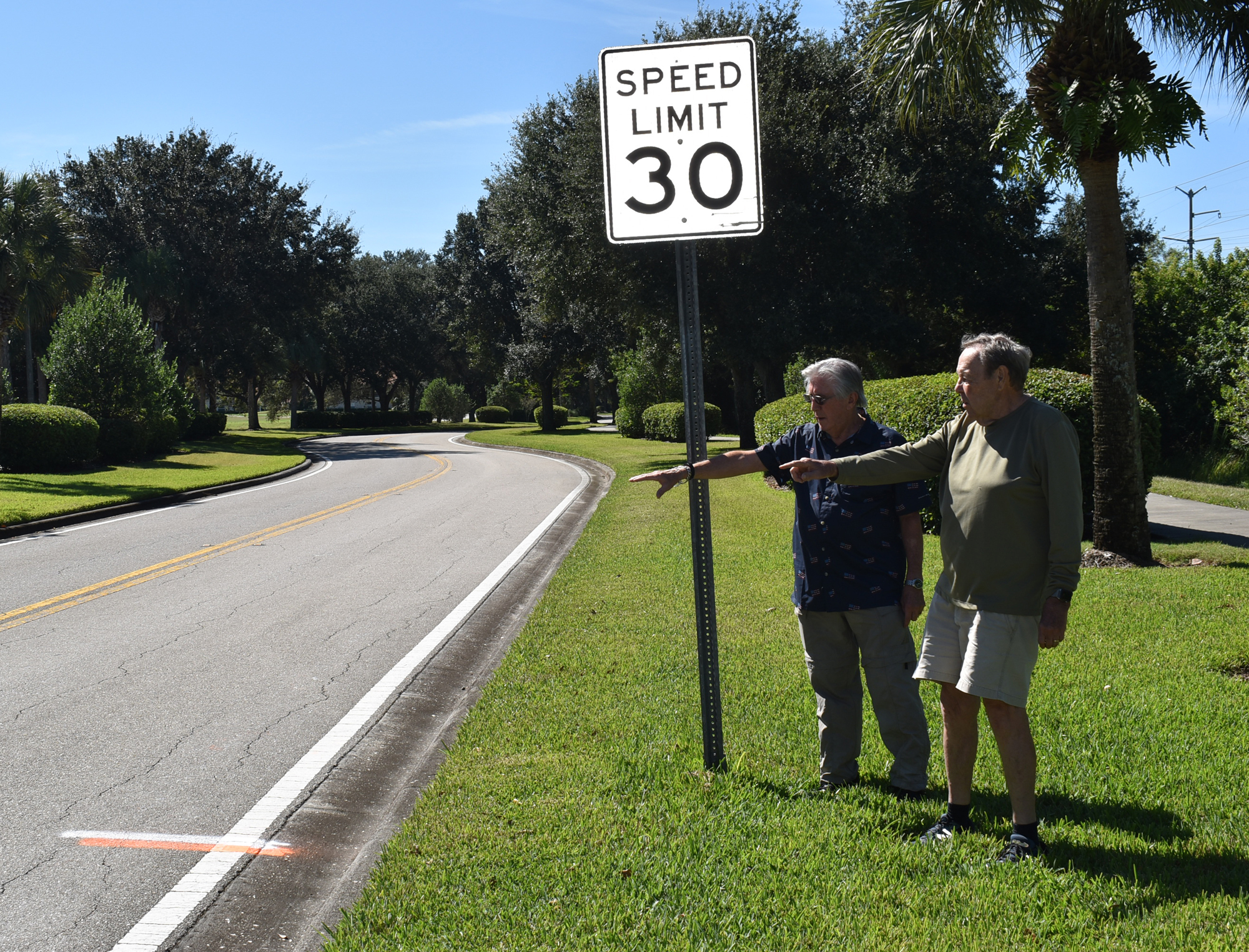 Darby Connor (left) and Peyton Phillips point out the location of where the second of three speed tables will be constructed along Tara Blvd. between Tara Preserve and Linger Lodge Road. Photo by Scott Lockwood.