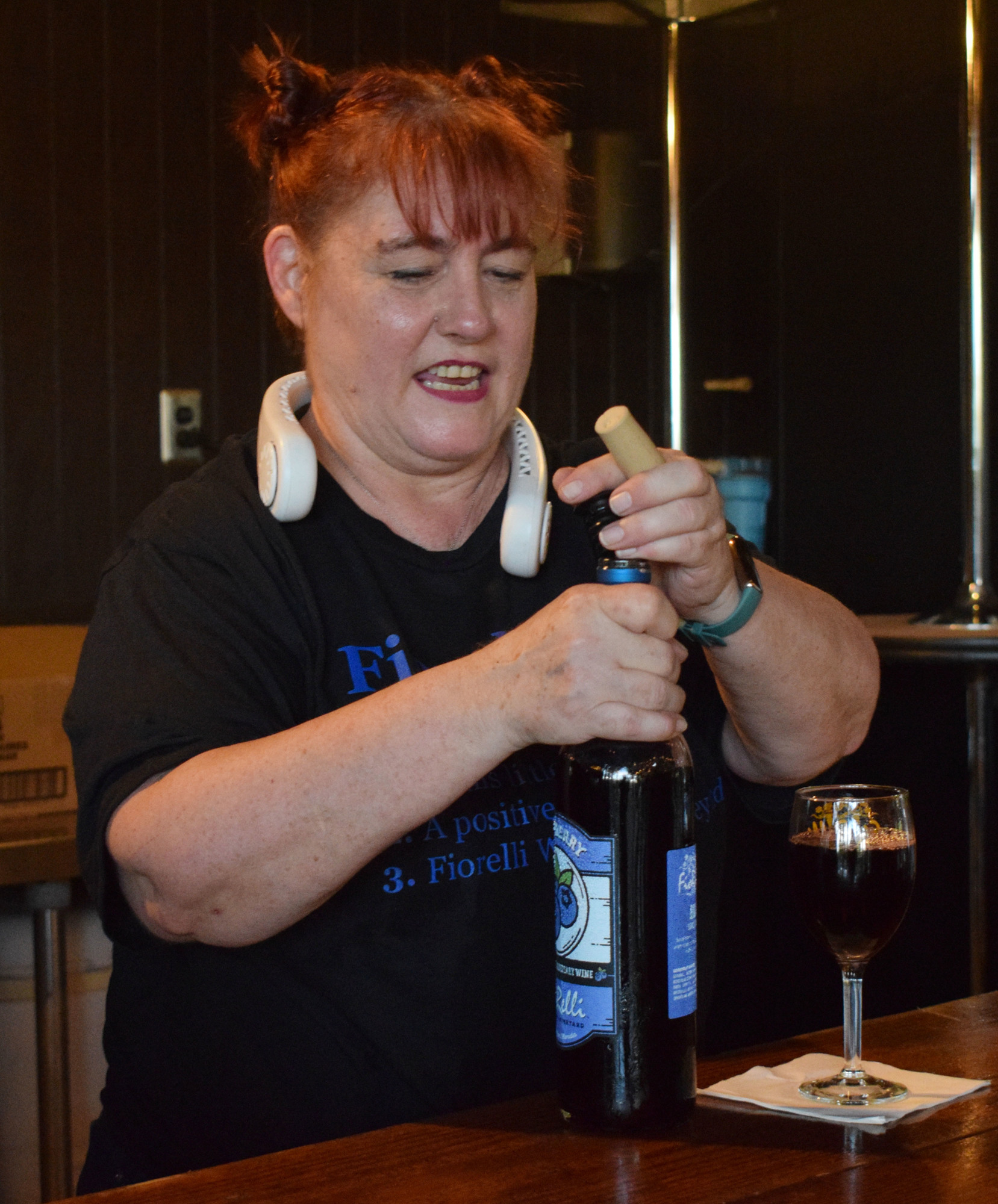 Lisa Gaines, a bartender at Fiorelli Winery and Vineyard, serves a guest a glass of wine.