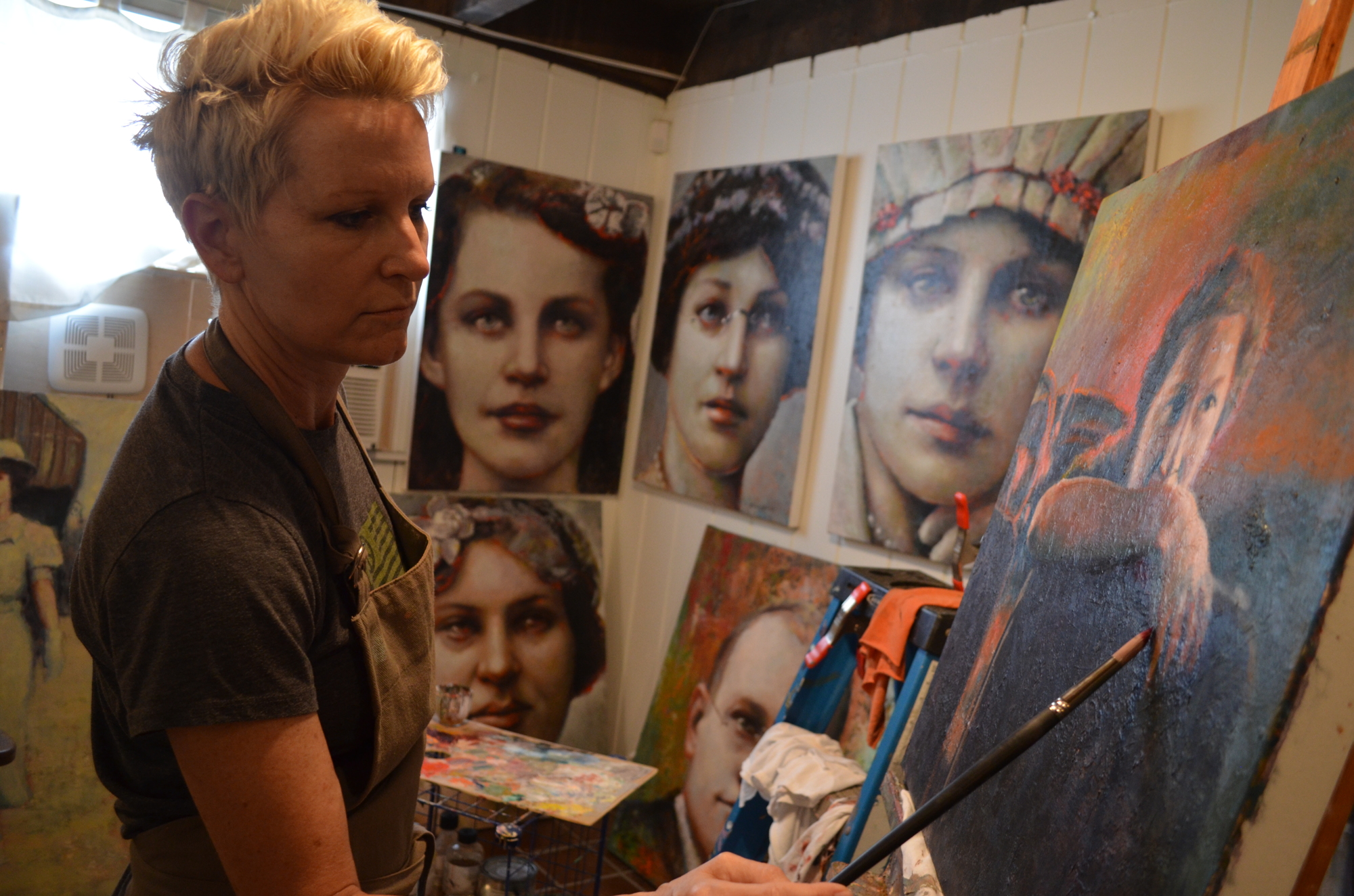 Victoria Arendt puts the final touches on a recent painting.