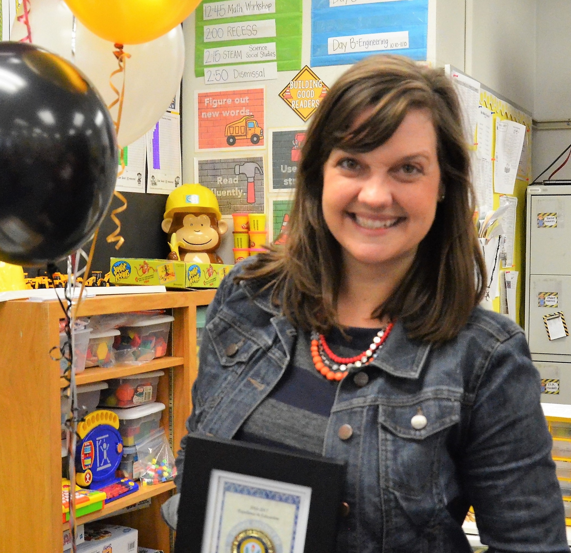 Courtney Walker, second grade teacher at Bashaw Elementary, hods her award for being a finalist for Manatee County 