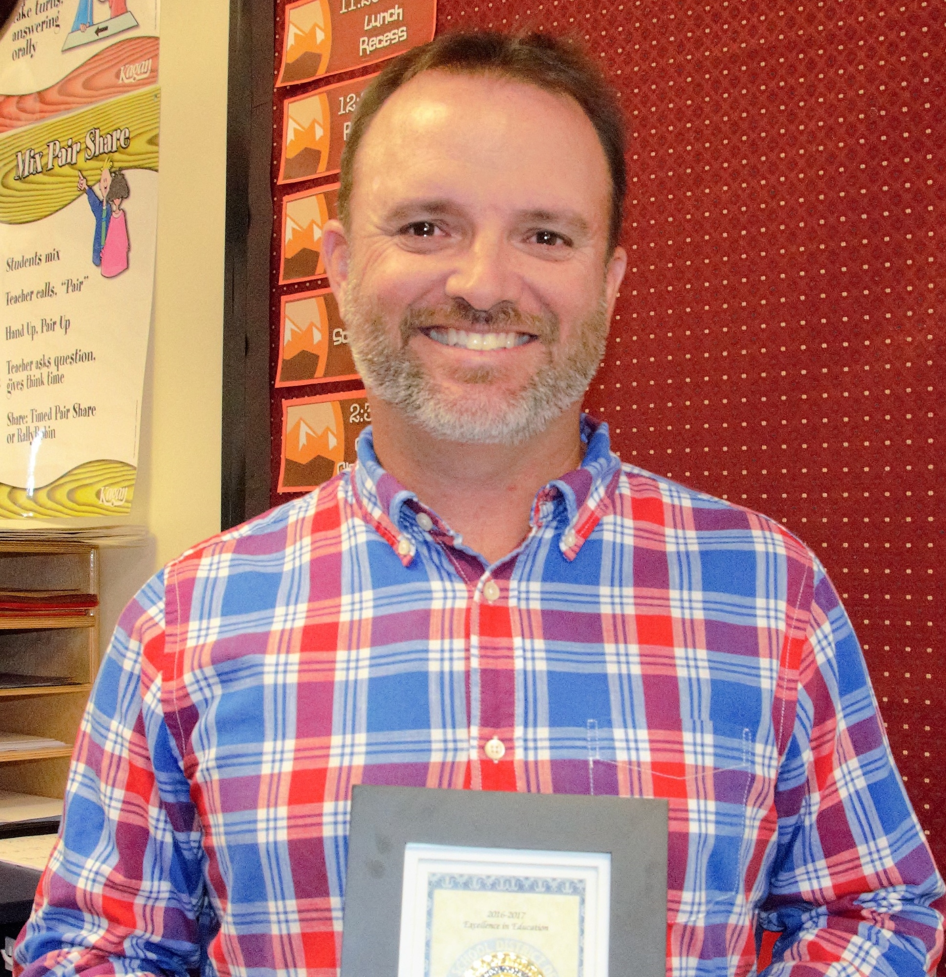 Nicholas Leduc, fourth grade teacher at Braden River Elementary, holds his award for being a finalist for the Manatee County 
