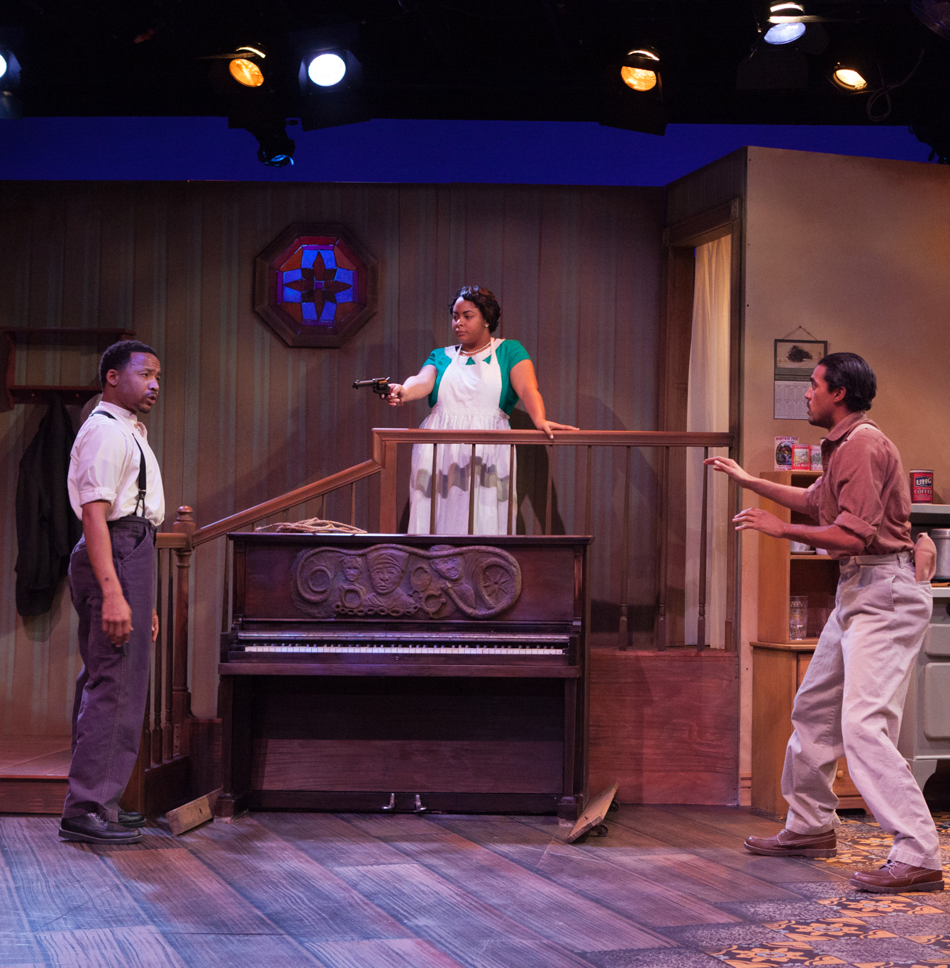 Berniece (Noelle Strong) faces off with her brother, Boy Willie (Earley Dean, left), as he and Lymon (Michael Mendez) attempt to remove the piano. Photo by Don Daly