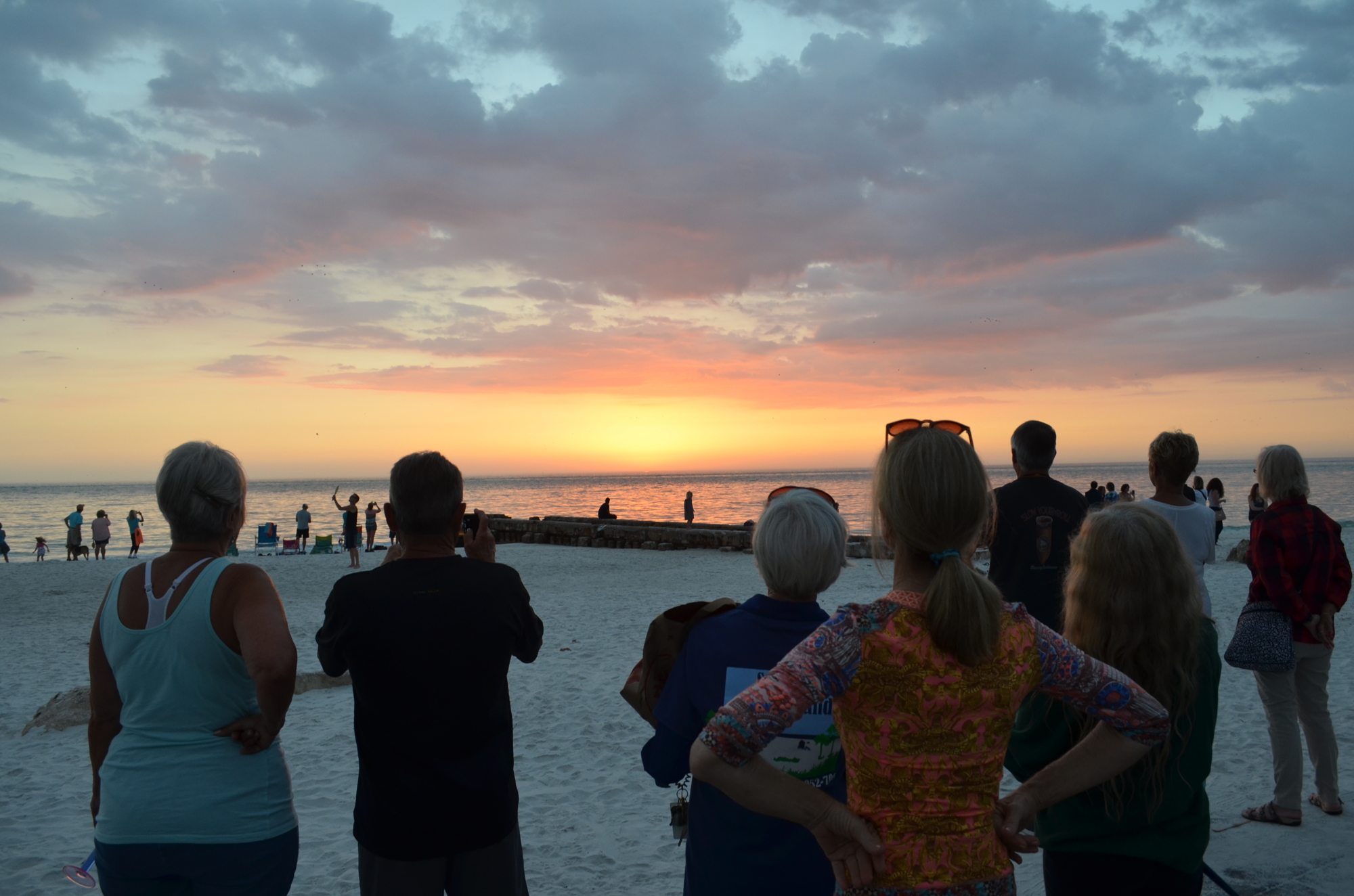 Visitors to Siesta Key Beach take in the sunset at Beach Access 2. Even among those off-put by the increased tourism, Siesta’s natural beauty remains alluring.