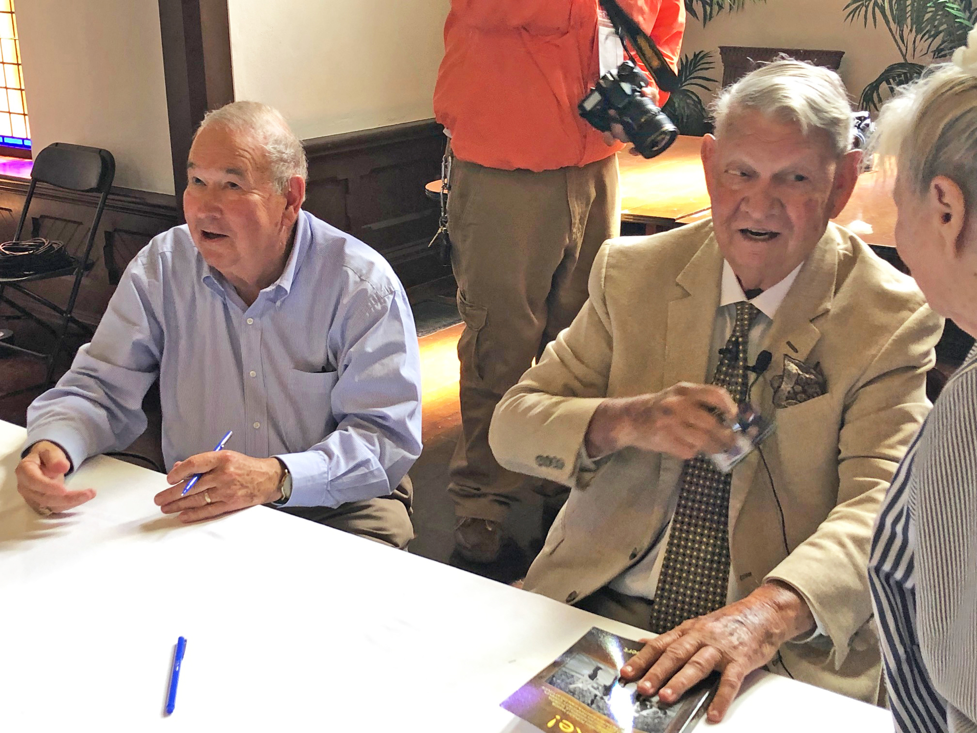 Author Mike Tolbert and former Mayor Jake Godbold greet supporters as they sign books at at Old St. Andrews Church.