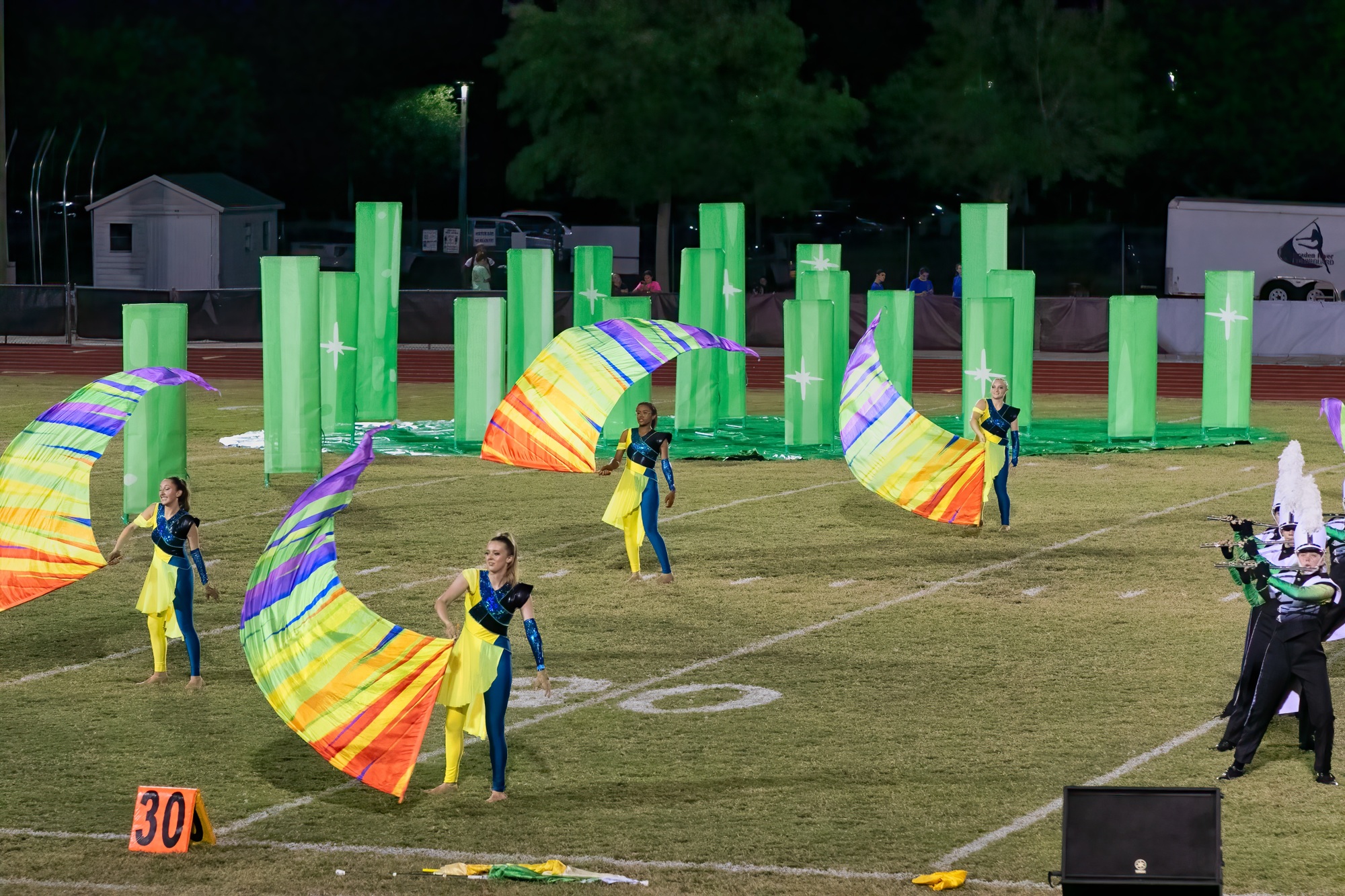 Lakewood Ranch High School color guard members Jasmine Burden, Paige Thompson, Mya Stuart and Alyssa Soria work with rainbow flags to match the show's theme. Courtesy photo.