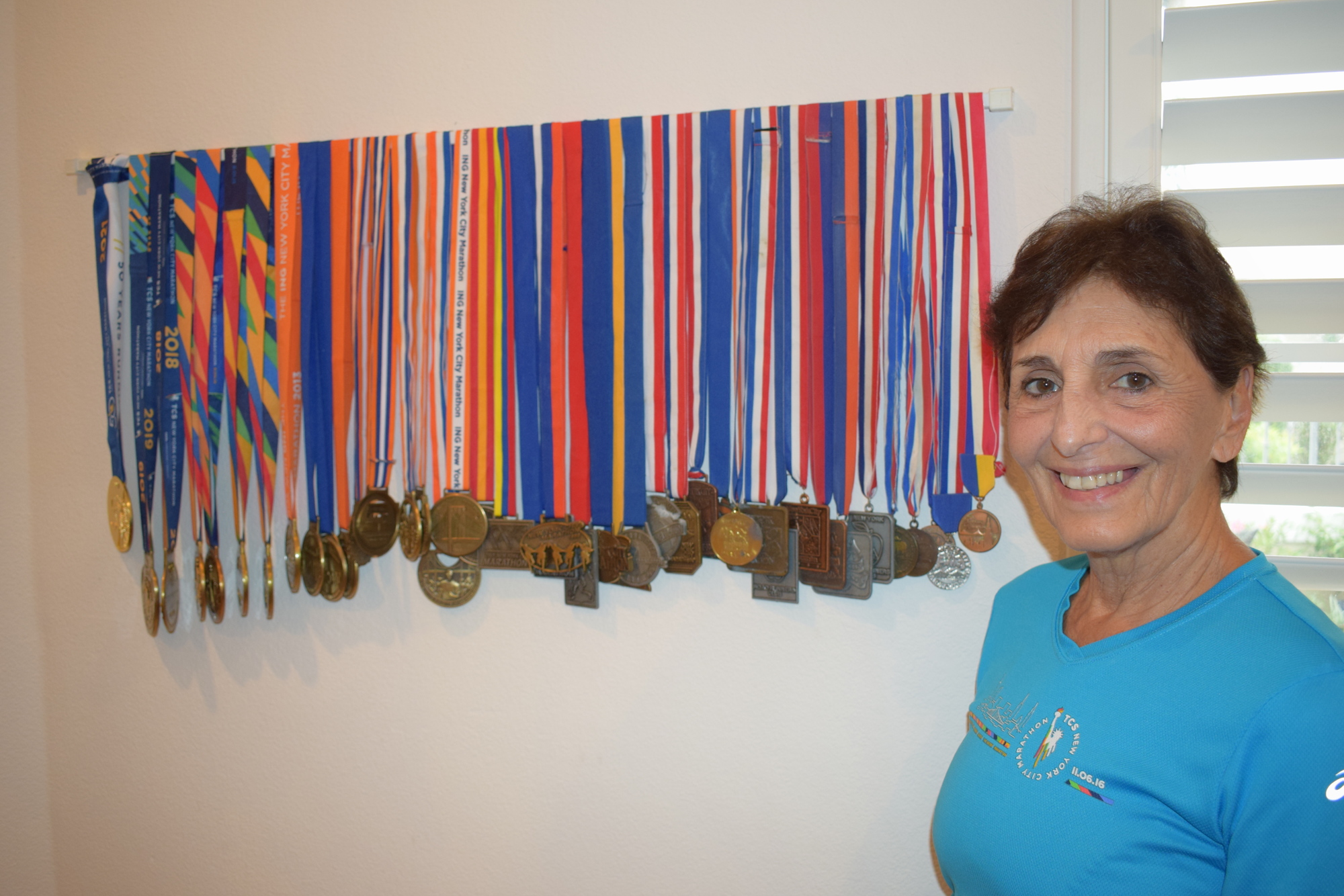 Connie Lyke-Brown's husband says he is going to need to build her another rack to hold her New York City Marathon medals.