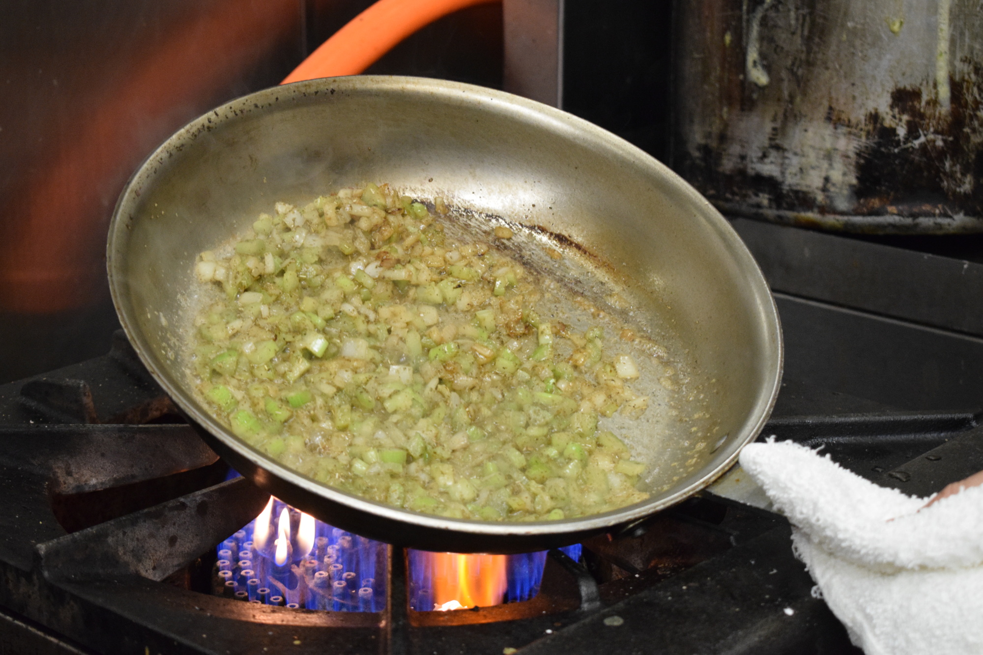 Greg Campbell, the executive chef and director of operations at the Grove restaurant, sautés onions and celery in butter.