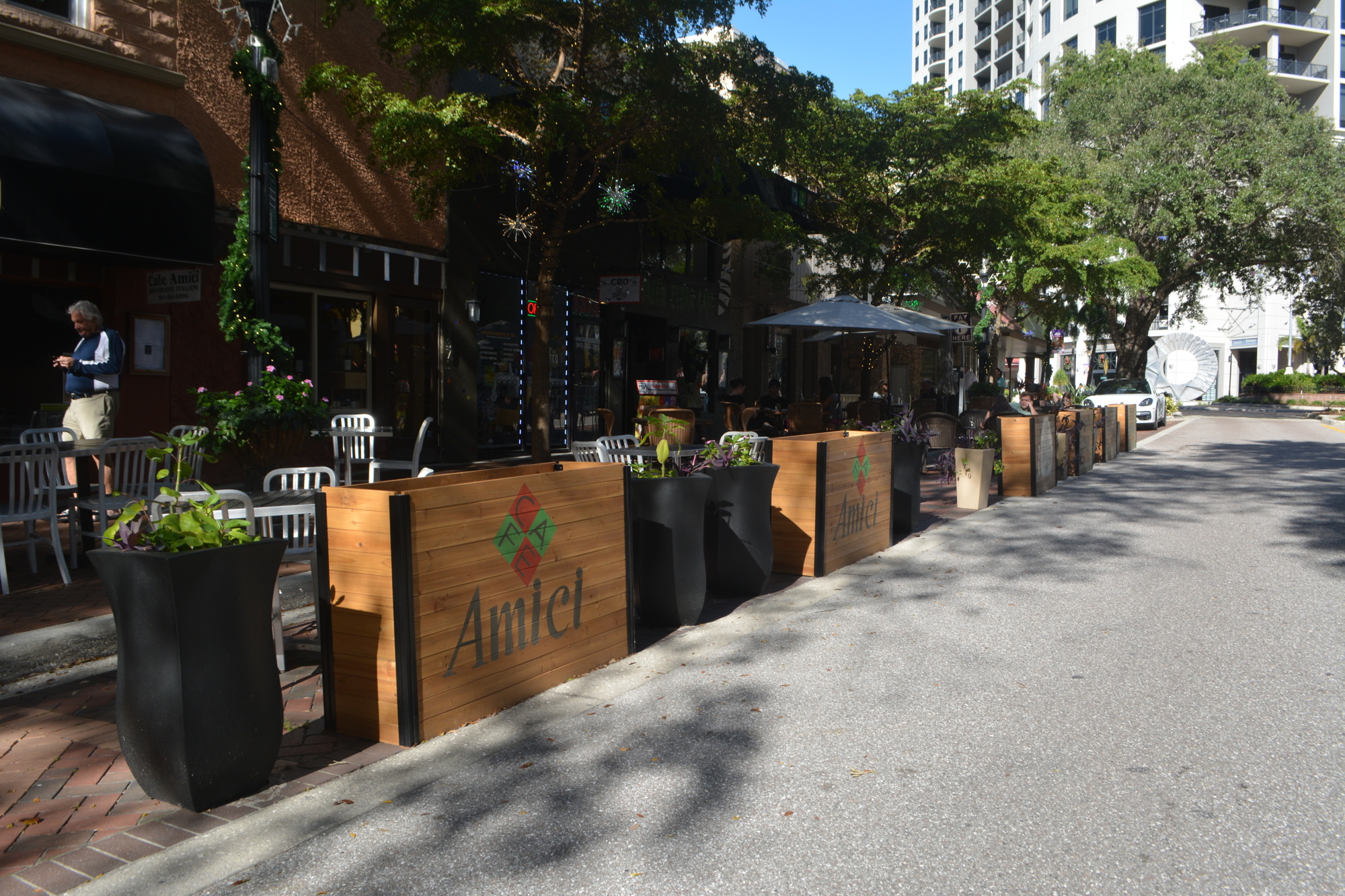Businesses such as Green Zebra Café and Café Amici have invested in more substantive dividers between their expanded outdoor seating areas and the road.