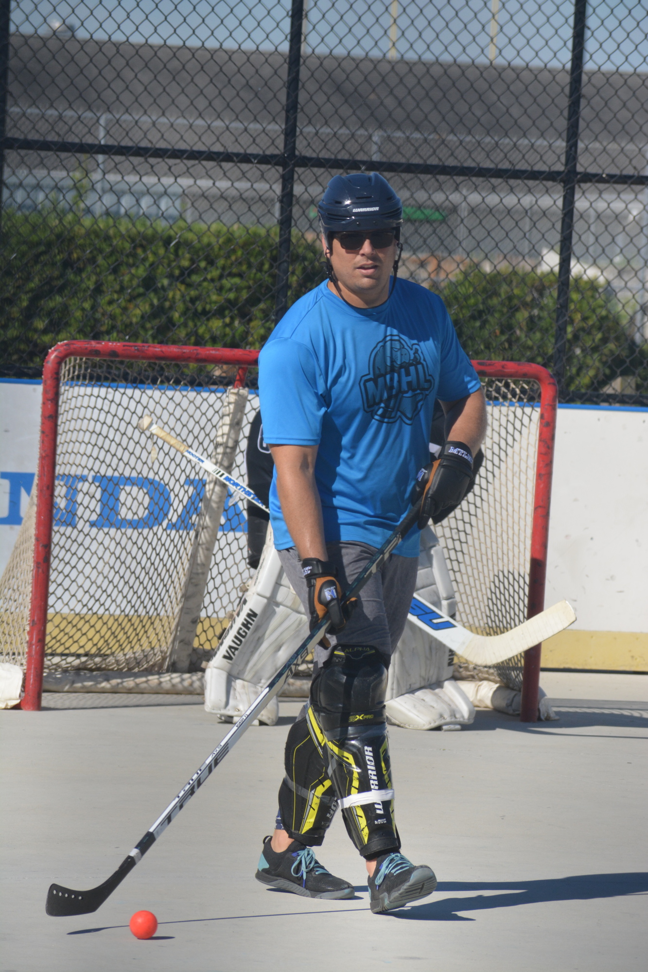Bradley Gustafson looks for an open teammate during a Dec. 4 Manatee Ball Hockey League game. Gustafson started the league, which also has a youth division, because his son wanted an opportunity to play hockey with his friends.