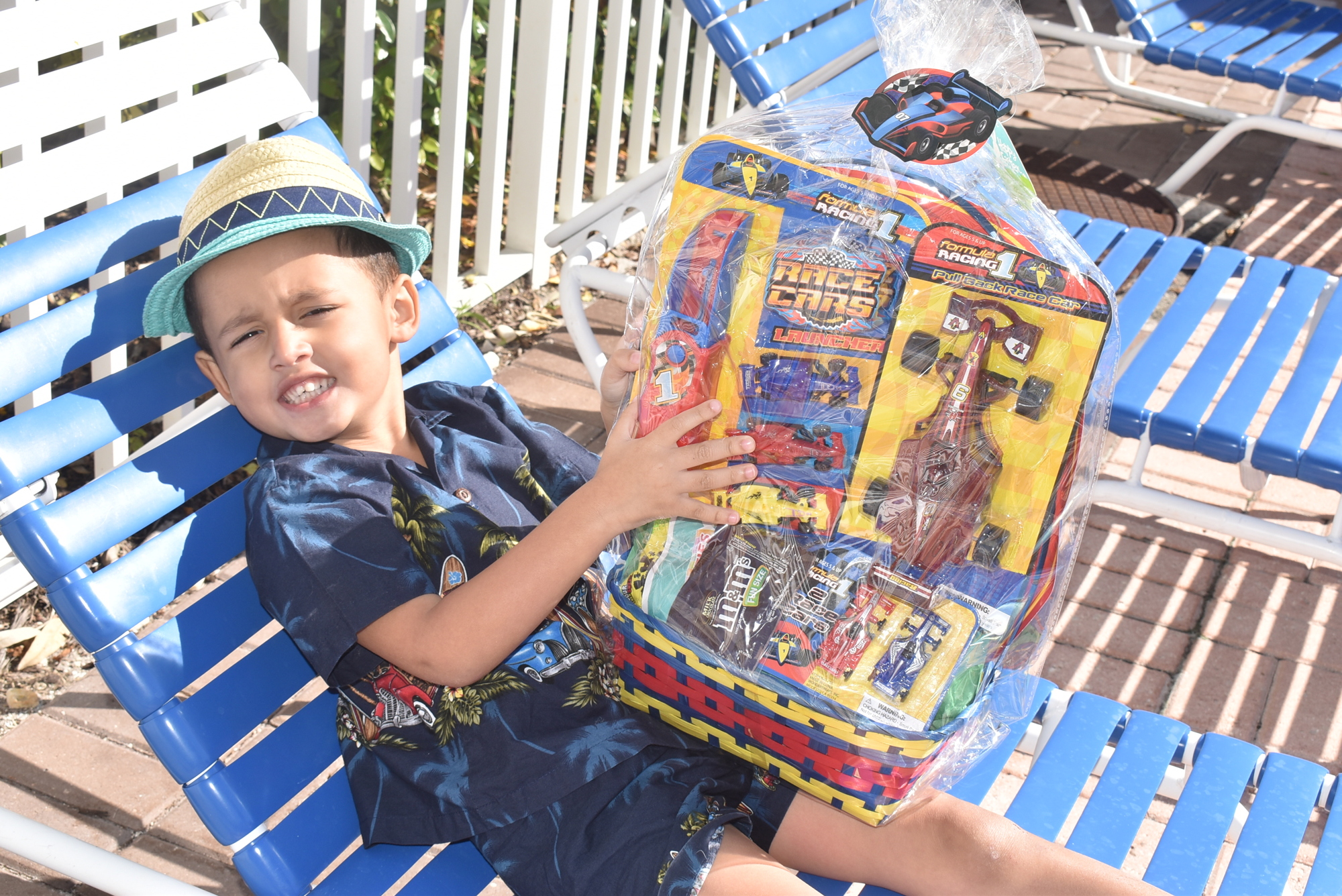 APRIL:  King Michael relaxes with his Easter basket filled with toy cars.