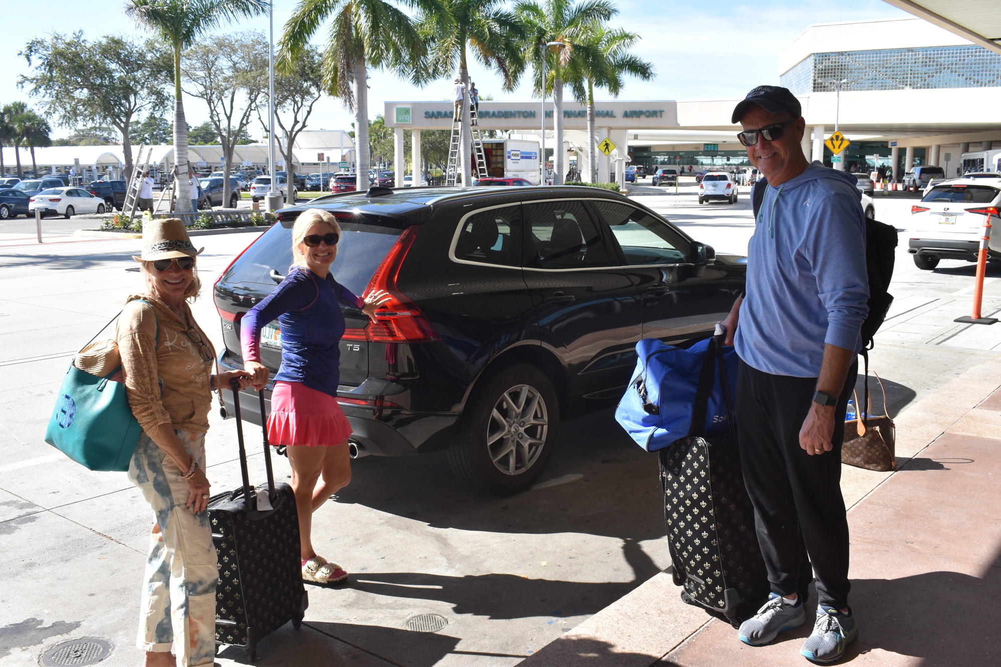 Sarasota resident Stephanie Flatt (center) drops Jenny (left) and Bill Scott (right) off for a flight to Chicago.