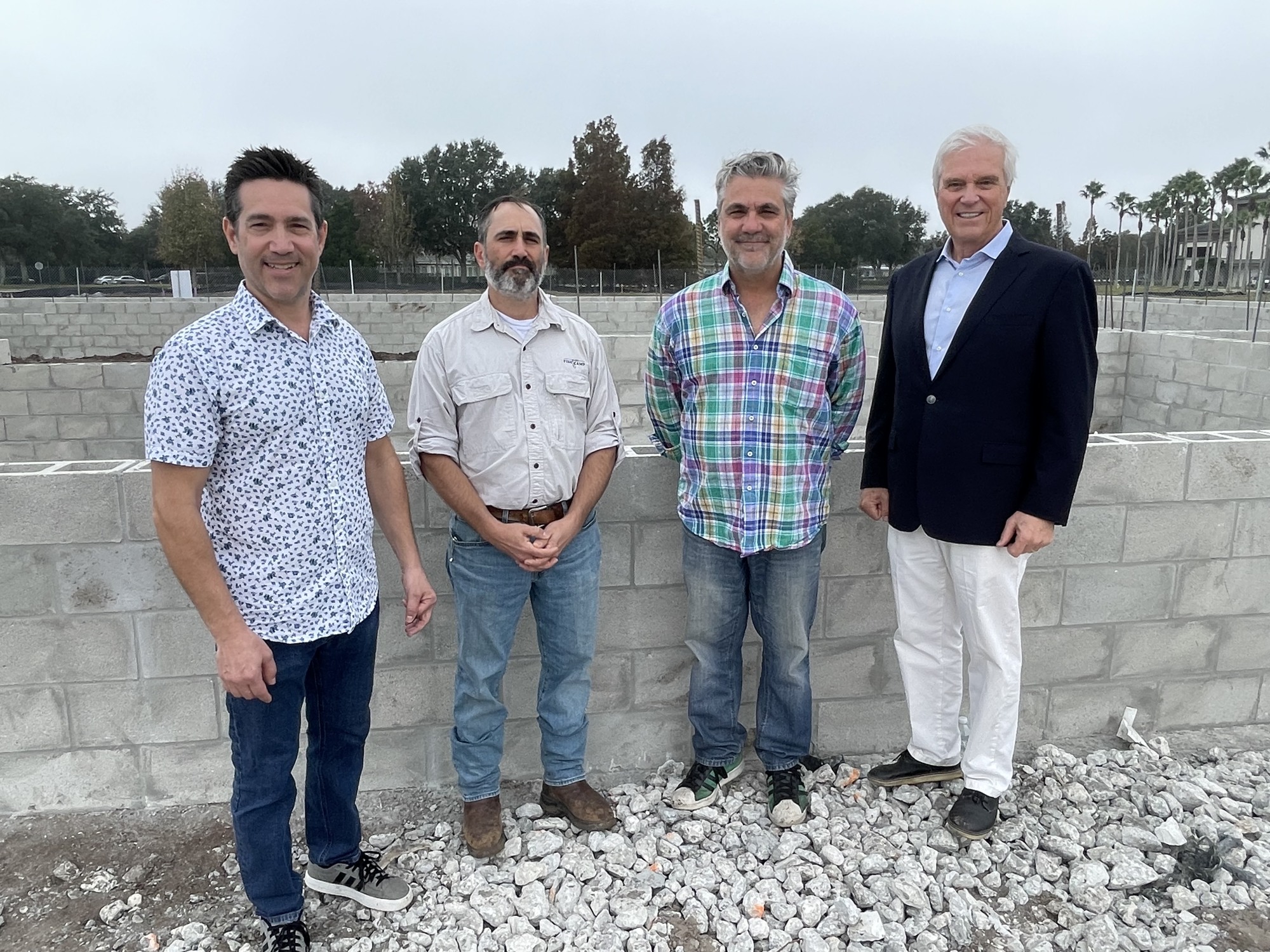 Rob Caragiulo, Paul Caragiulo, Mark Caragiulo and CASTO principal Brett Hutchens stand at the site of what will become Owen's Fish Camp at Center Point.