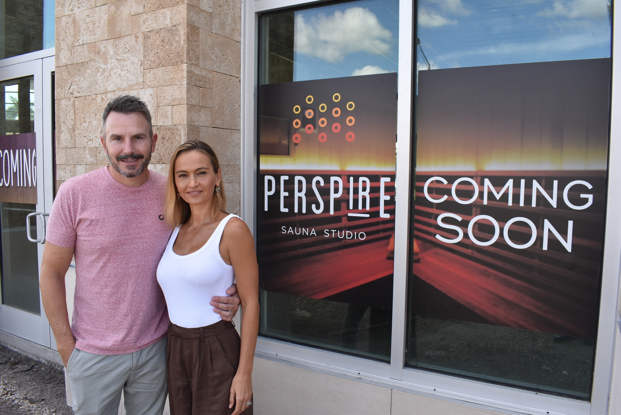 Gavin and Franciska Bray stand outside the future home of their Perspire Sauna Studio at University Town Center. The studio, which features infrared technology and comes with several important health benefits, will open in March.