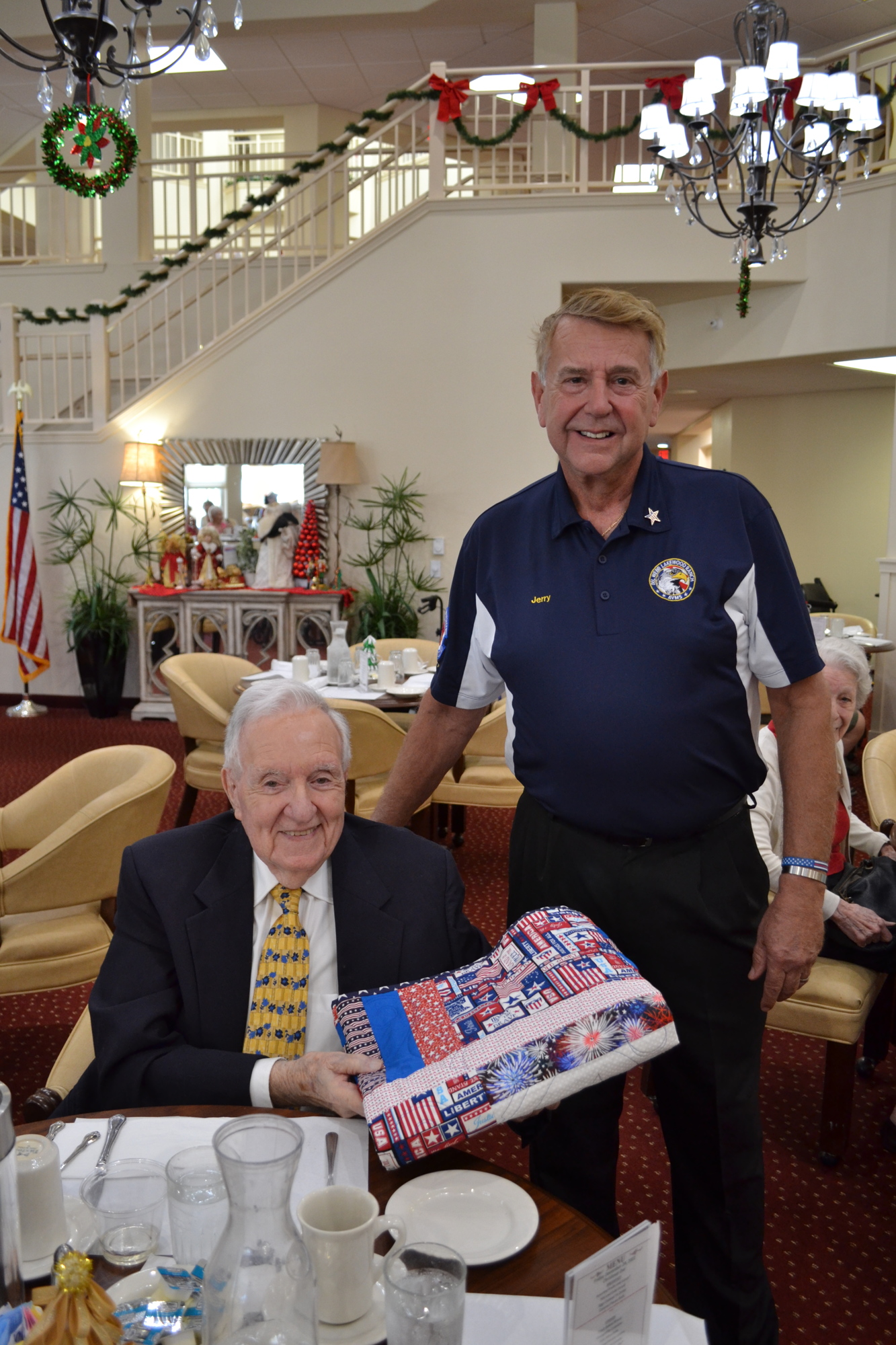 Cypress Springs' Gracious Retirement Living's Joe Barbera thanks Jerry Hufford, the president of Del Webb's Association of Veterans and Military Supporters, for the patriotic quilt. Courtesy photo.