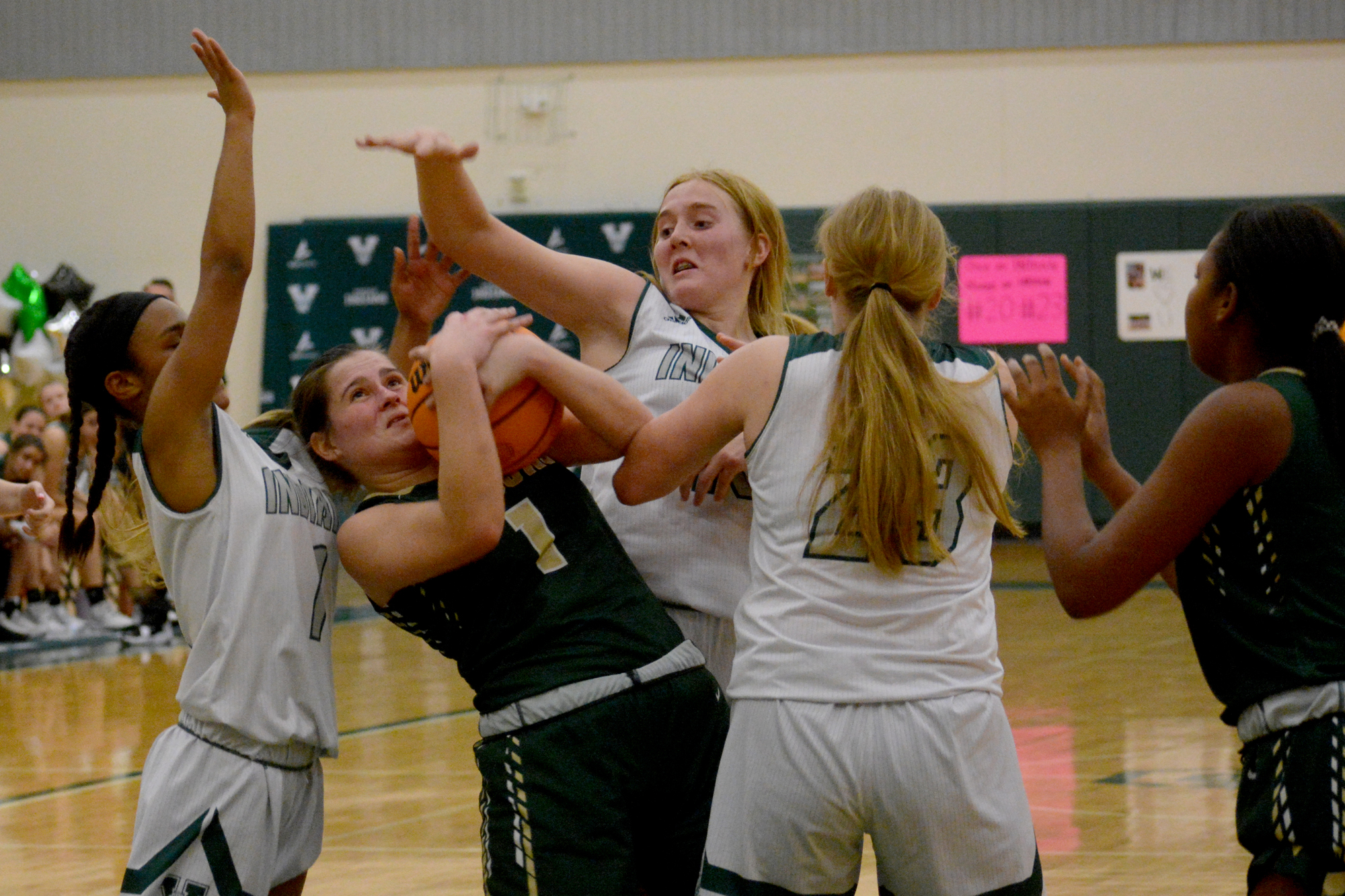 Despite being a guard, Jamie Springstead often plays in the post, using her physicality to her advantage. Here she grabs a rebound through Veince's Addison Ivery, Jayda Lanham and Ella Opsatnick.