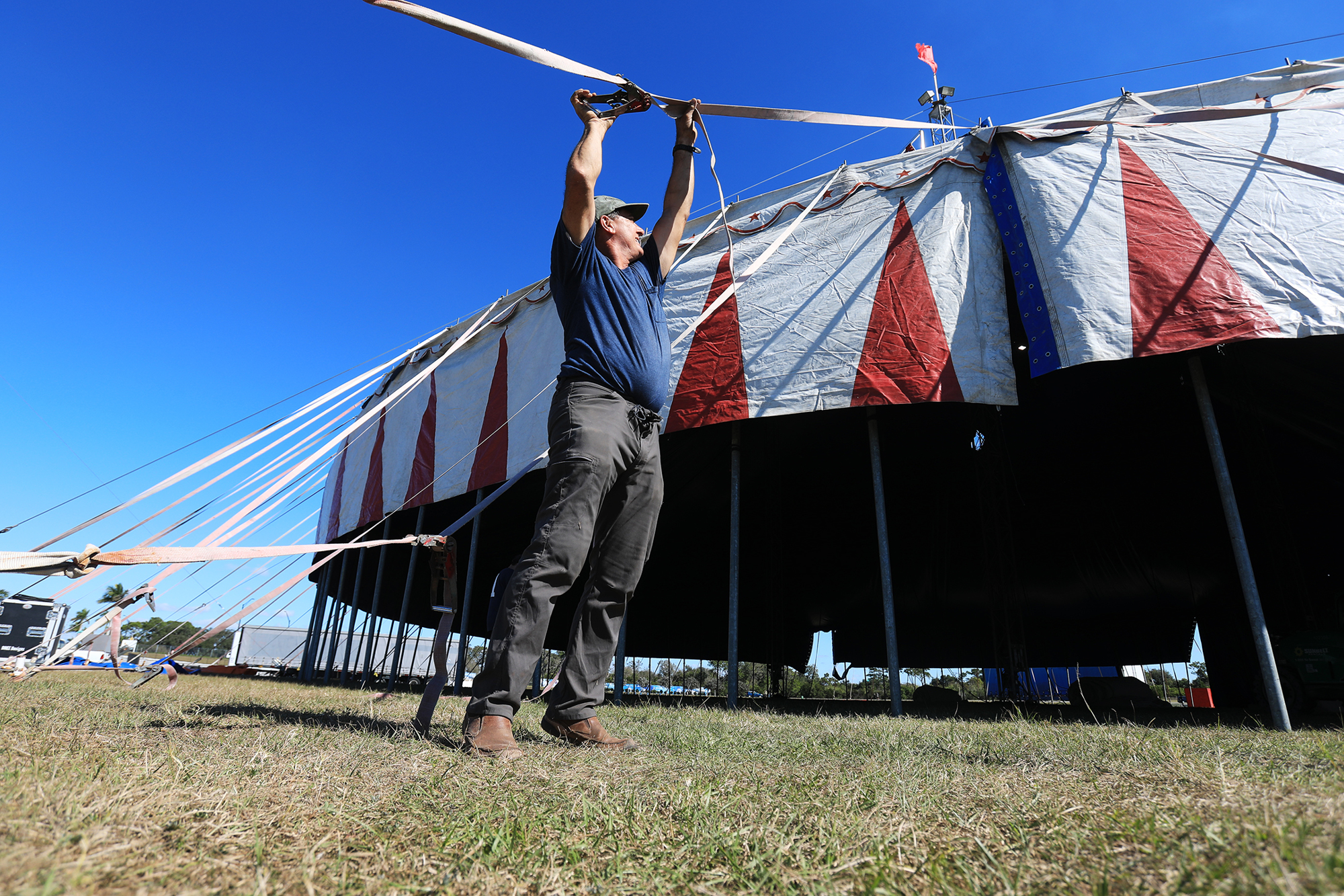 Luis Garcia works on the outside of the tent. (Photo: Harry Sayer)