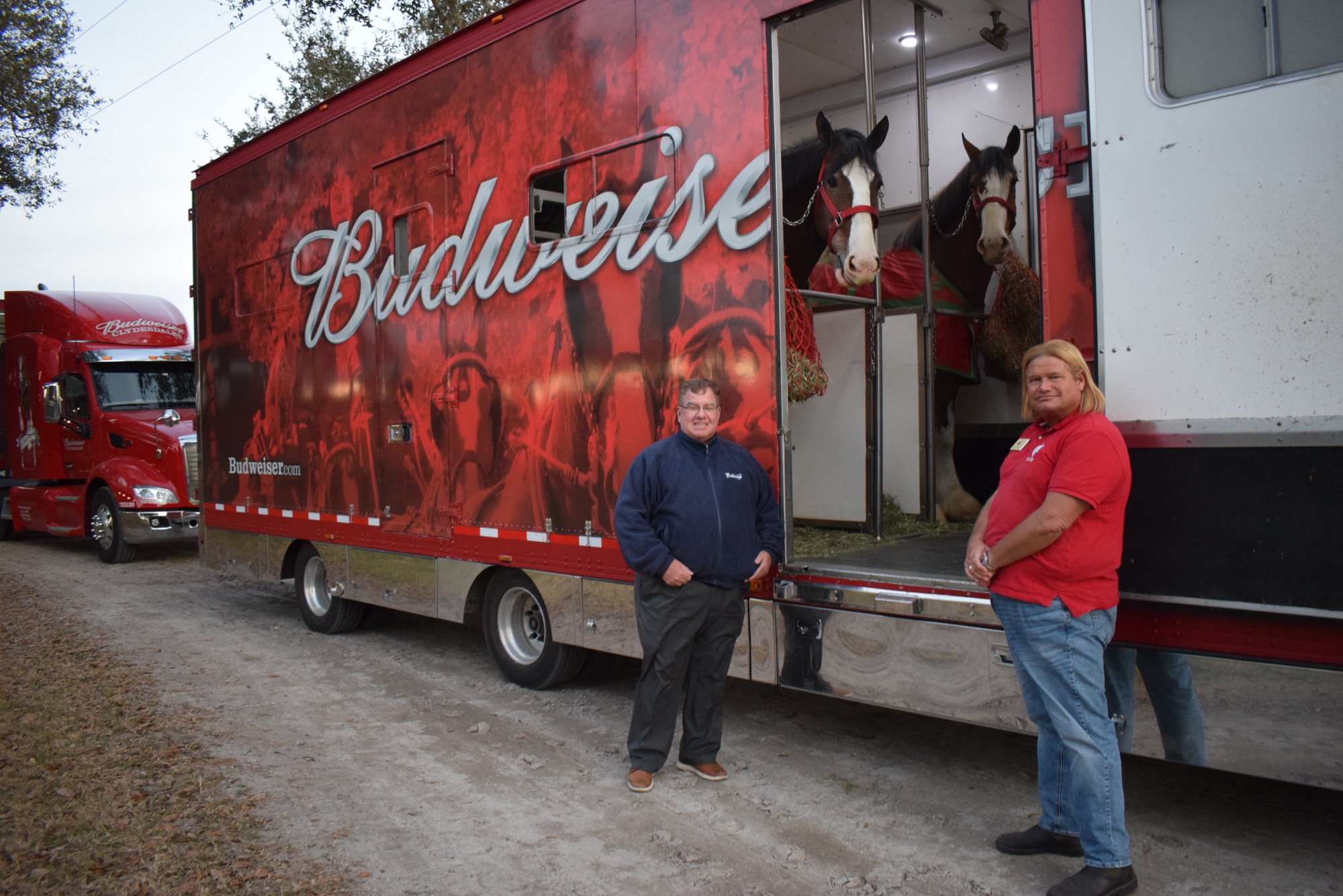 Gold Coast Eagle Distributing's Hugh Shields and the Sarasota Polo Club's Ron Trytek, greet the Budweiser Clydesdales.